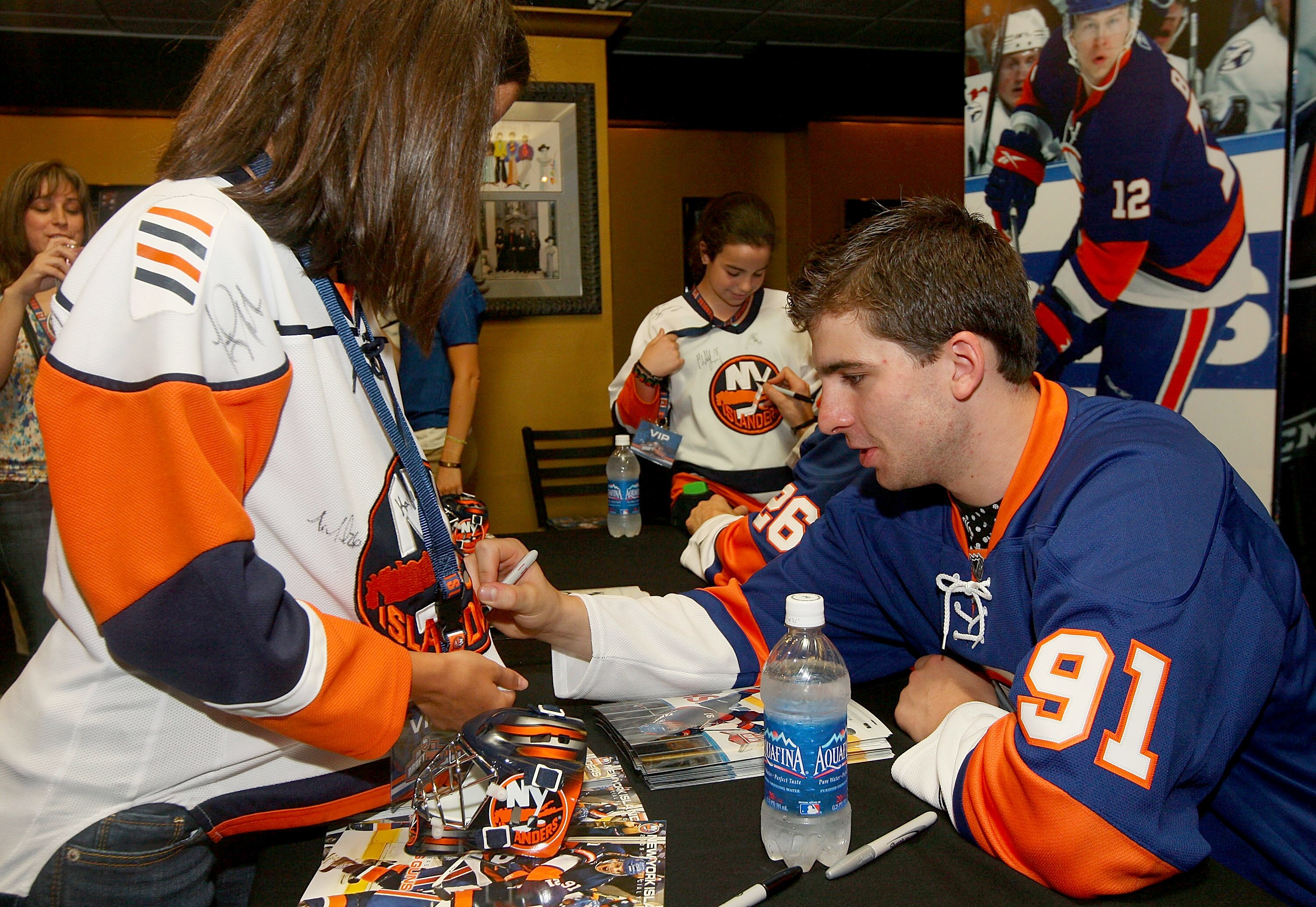 UNIONDALE, NY - JUNE 25: John Tavares #91 signs autographs during the New York Islanders Draft Day Party on June 25, 2010 at Nassau Coliseum in Uniondale, New York.  (Photo by Mike Stobe/Getty Images for New York Islanders)
