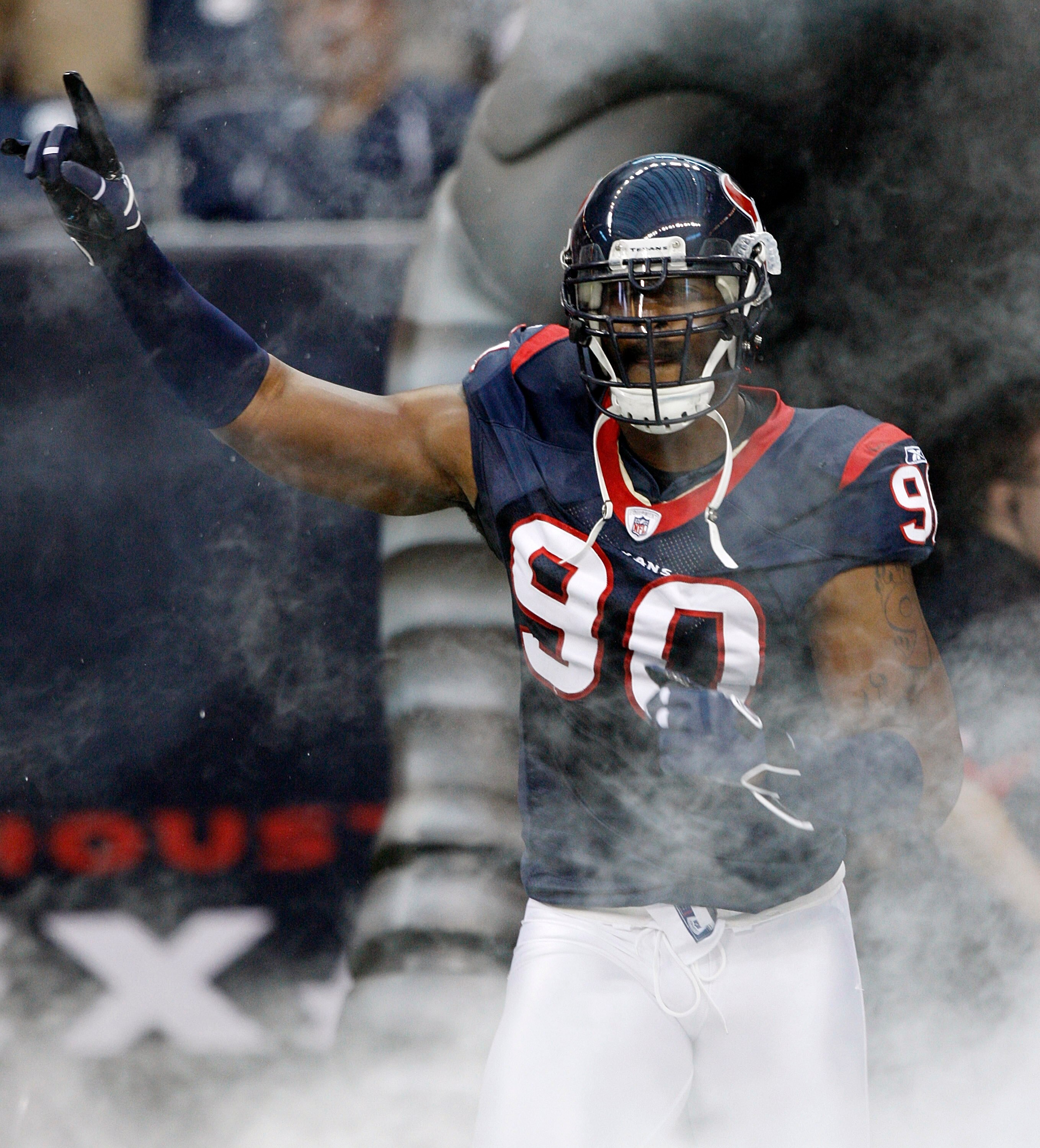 HOUSTON - AUGUST 28:  Defensive end Mario Williams #90 of the Houston Texans is introduced before a preseason game against the Dallas Cowoys at Reliant Stadium on August 28, 2010 in Houston, Texas.  (Photo by Bob Levey/Getty Images)