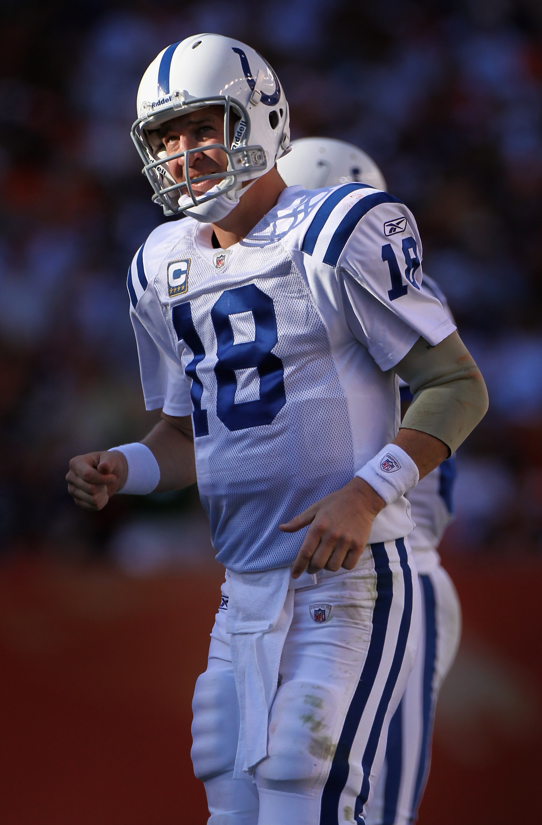 DENVER - SEPTEMBER 26:  Quarterback Peyton Manning #18 of the Indianapolis Colts takes the field to run the offense against the Denver Broncos at INVESCO Field at Mile High on September 26, 2010 in Denver, Colorado. The Colts defeated the Broncos 27-13.  