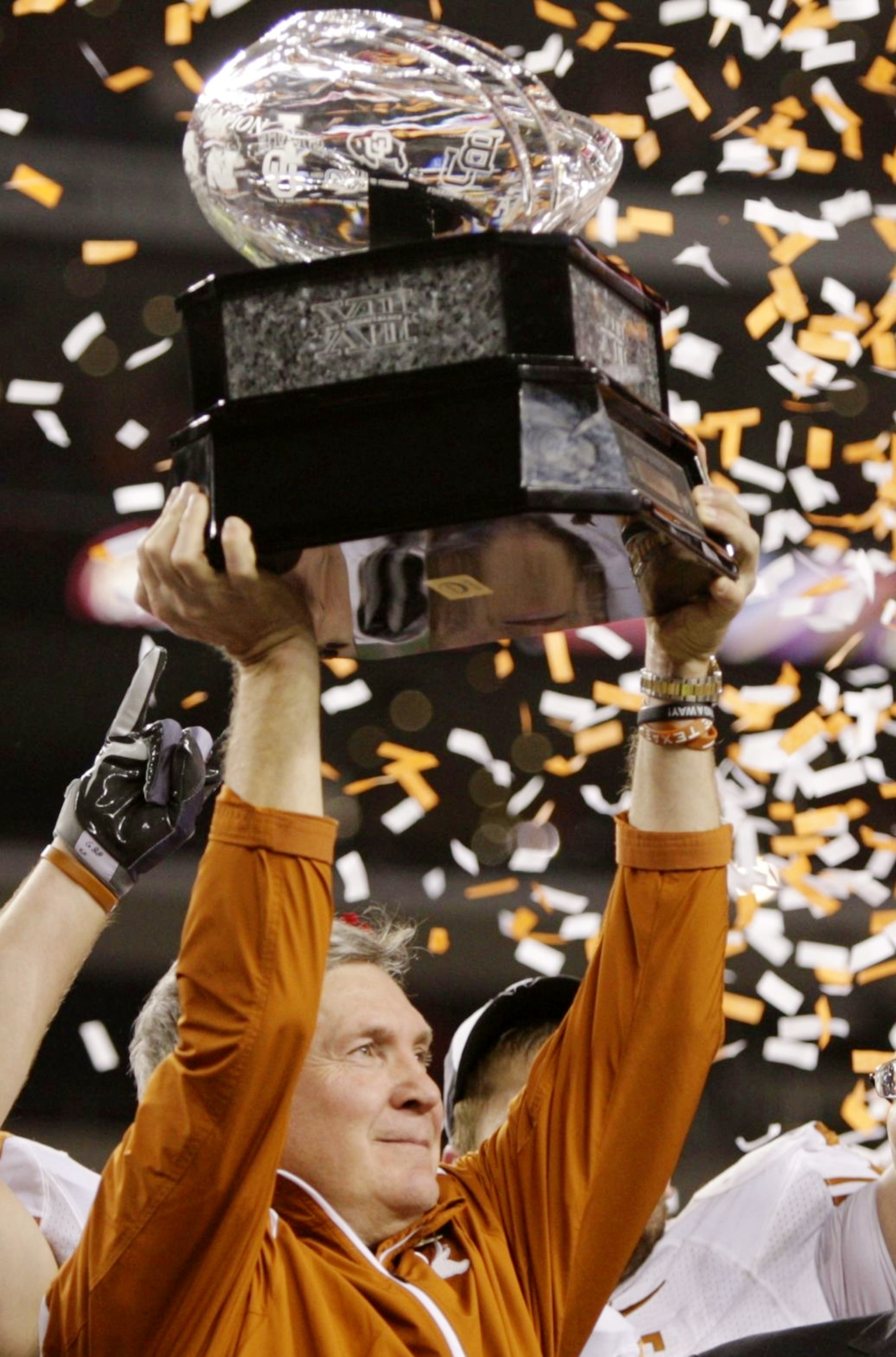 ARLINGTON, TX - DECEMBER 5: Head coach Mack Brown of the Texas Longhorns lifts the trophy after his teams 10-6 victory over the Nebraska Cornhuskers in the game at Cowboys Stadium on December 5, 2009 in Arlington, Texas. (Photo by Jamie Squire/Getty Imag ARLINGTON, TX - DECEMBER 5: Head coach Mack Brown of the Texas Longhorns lifts the trophy after his teams 10-6 victory over the Nebraska Cornhuskers in the game at Cowboys Stadium on December 5, 2009 in Arlington, Texas. (Photo by Jamie Squire/Getty Imag