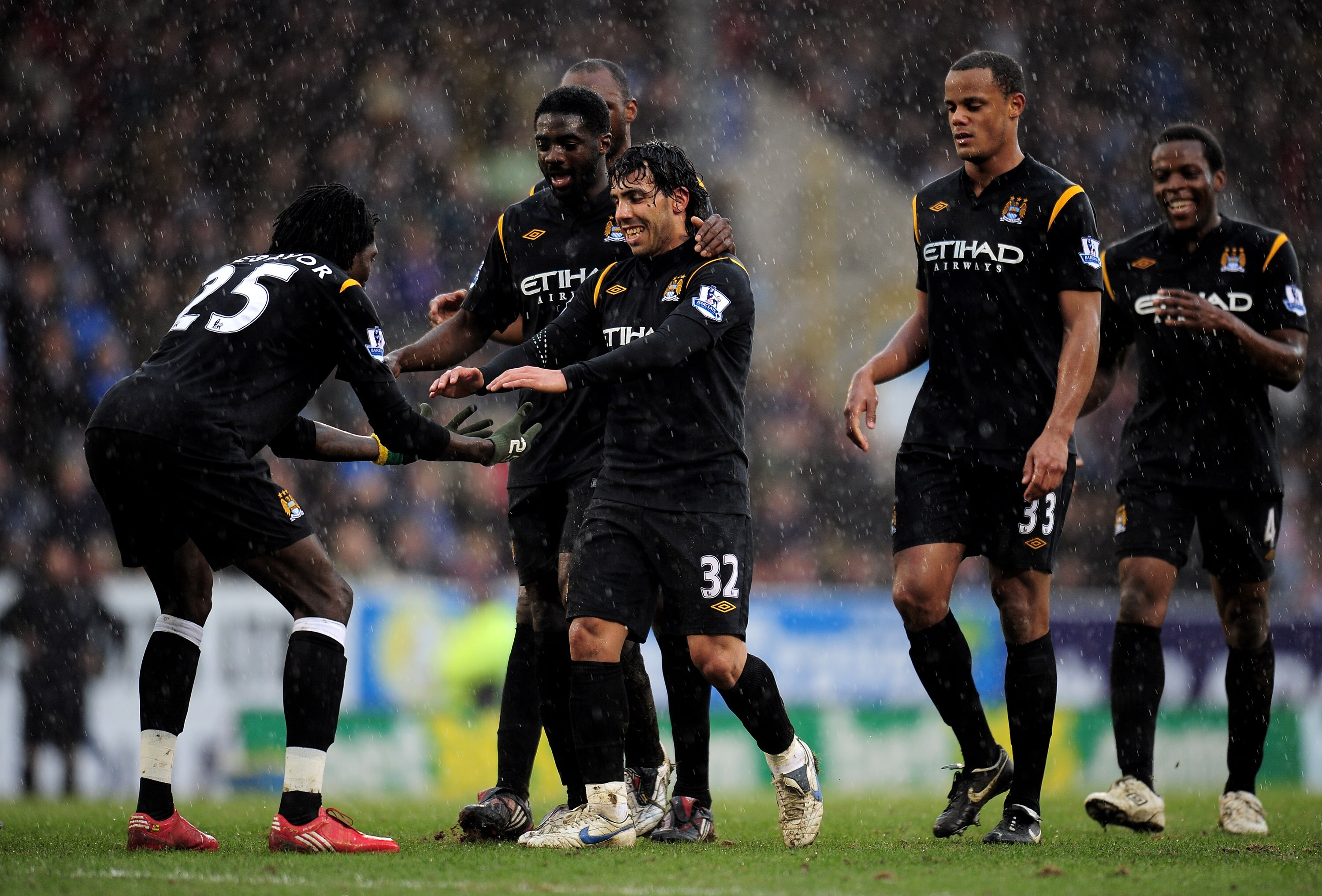 BURNLEY, ENGLAND - APRIL 03:  Emmanuel Adebayor of Manchester City celebrates scoring his team's fifth goal with team mate Carlos Tevez during the Barclays Premier League match between Burnley and Manchester City at Turf Moor on April 3, 2010 in Burnley,
