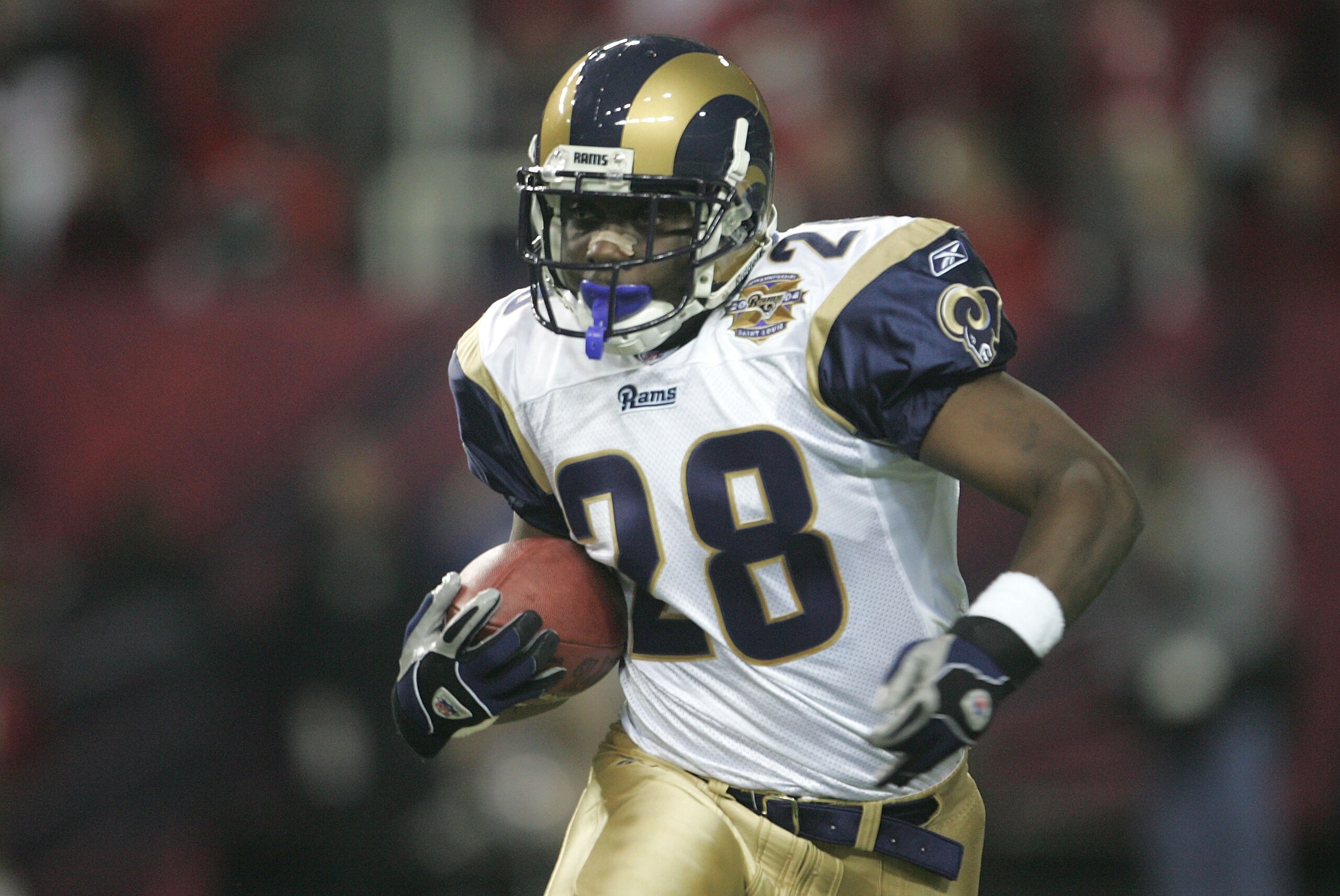 ATLANTA - JANUARY 15:  Marshall Faulk #28 of the St. Louis Rams runs against the Atlanta Falcons  during the NFC Divisional Playoff game at the Georgia Dome on January 15, 2005 in Atlanta, Georgia.  (Photo by Jeff Gross/Getty Images)