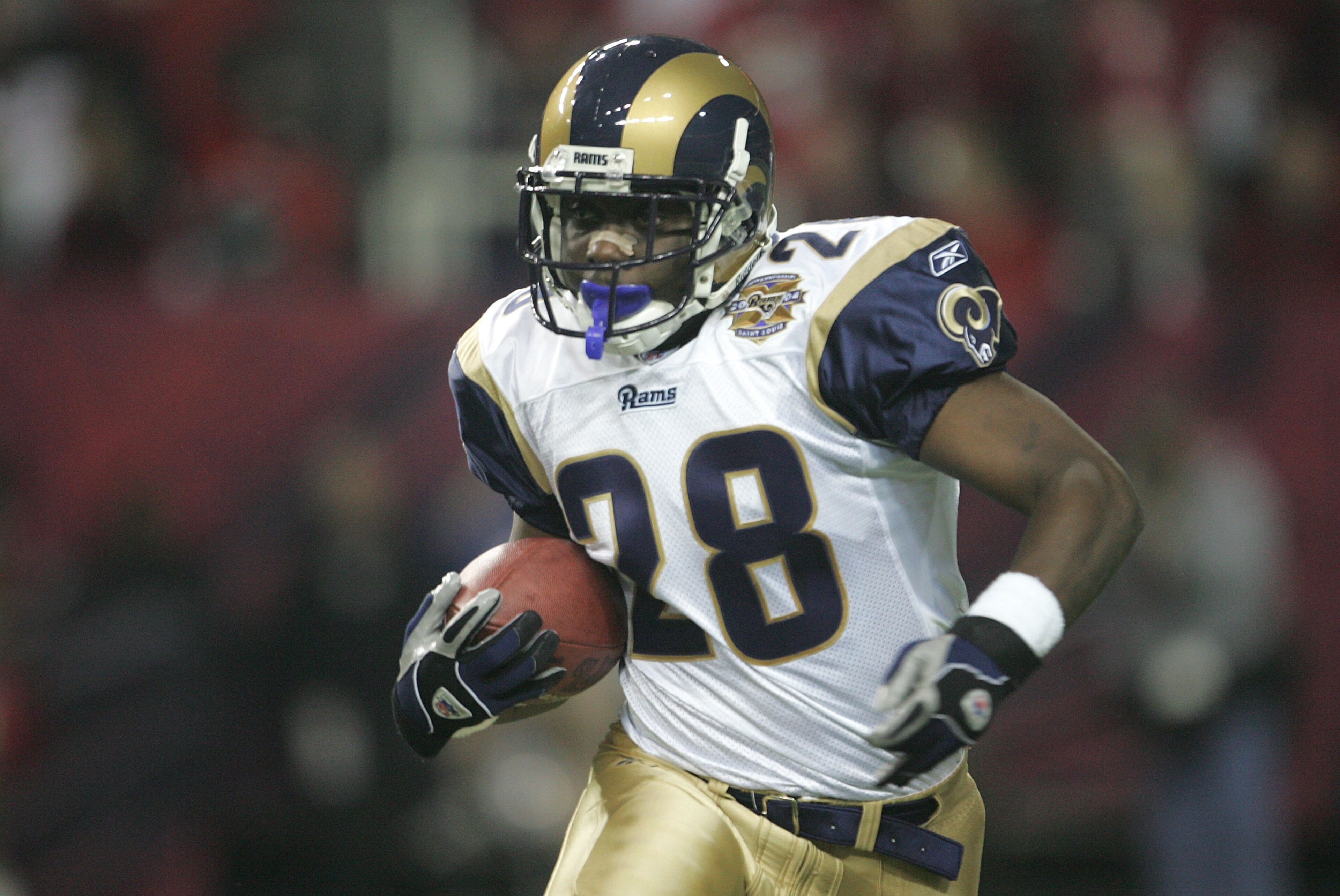 ATLANTA - JANUARY 15:  Marshall Faulk #28 of the St. Louis Rams runs against the Atlanta Falcons  during the NFC Divisional Playoff game at the Georgia Dome on January 15, 2005 in Atlanta, Georgia.  (Photo by Jeff Gross/Getty Images)