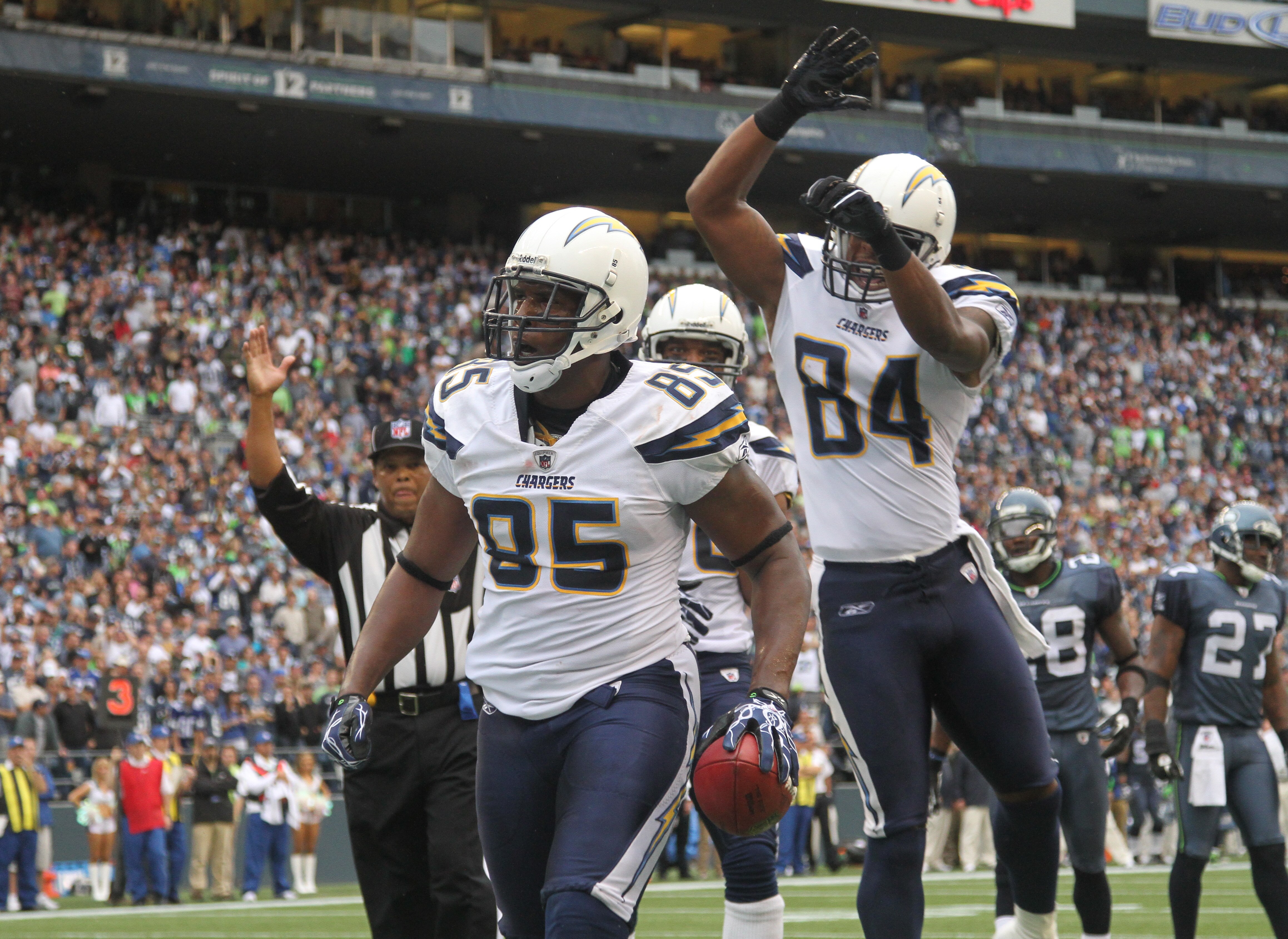 SEATTLE - SEPTEMBER 26:  Tight end Antonio Gates #85 of the San Diego Chargers celebrates with Malcom Floyd #80 and Buster Davis #84 after scoring a touchdown against the Seattle Seahawks at Qwest Field on September 26, 2010 in Seattle, Washington. (Photo