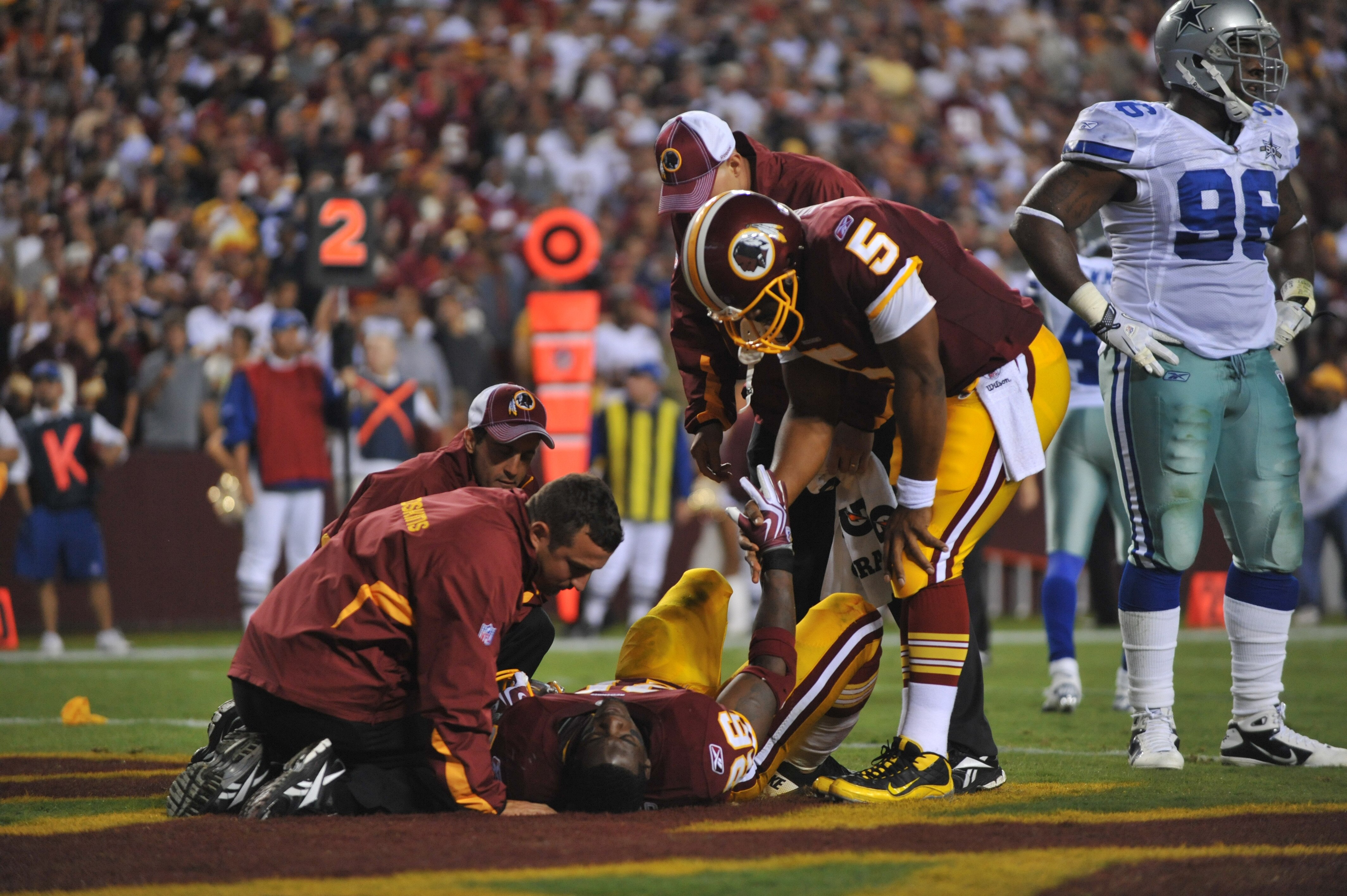 LANDOVER - SEPTEMBER 12:  Clinton Portis #26 of the Washington Redskins lies injured on the turf during the NFL season opener against the Dallas Cowboys at FedExField on September 12, 2010 in Landover, Maryland. The Redskins defeated the Cowboys 13-7. (Ph