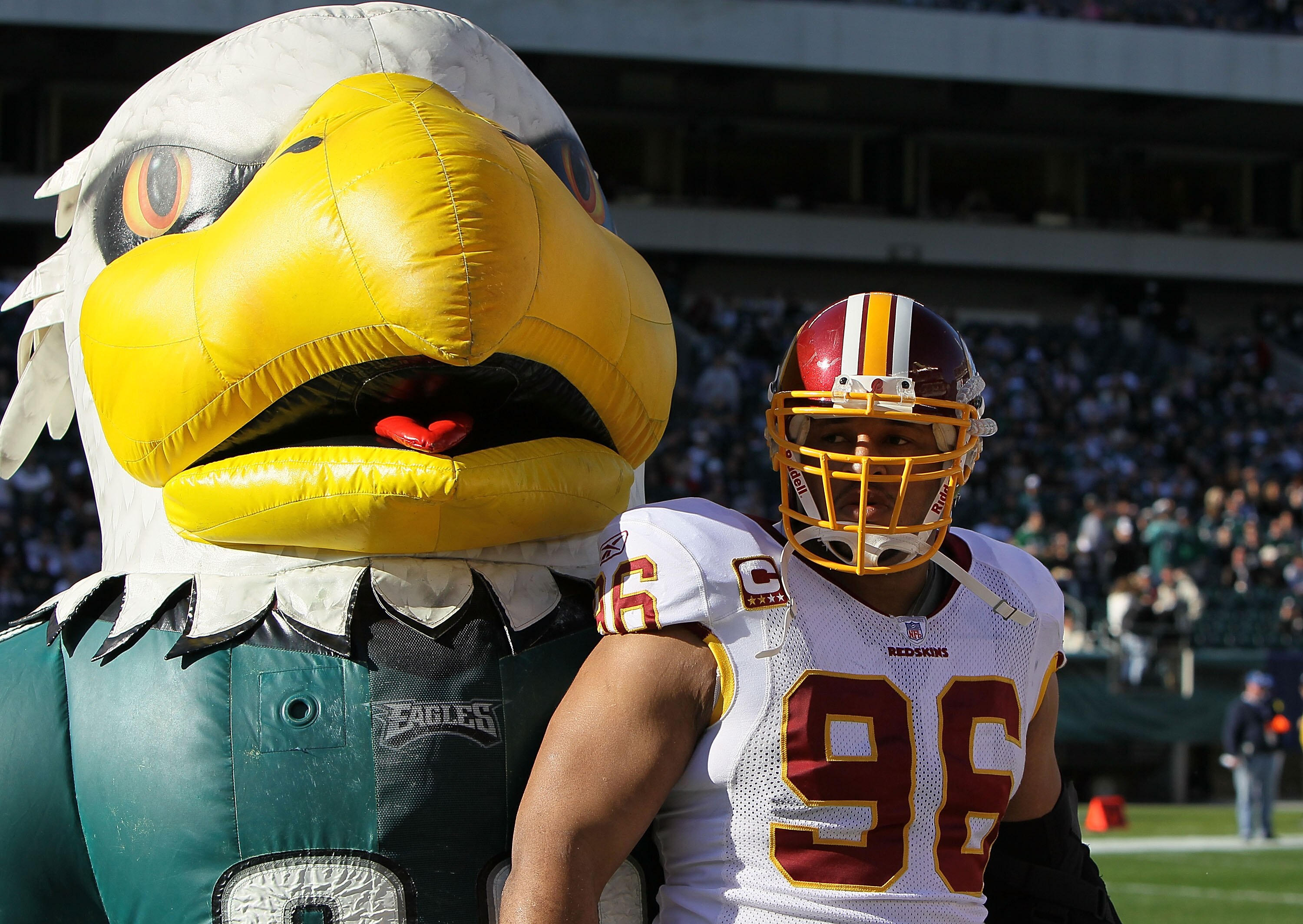 PHILADELPHIA - NOVEMBER 29:  The mascot of the Philadelphia Eagles stands with Cornelius Griffin #96 of the Washington Redskins before their game at Lincoln Financial Field on November 29, 2009 in Philadelphia, Pennsylvania.  (Photo by Al Bello/Getty Imag