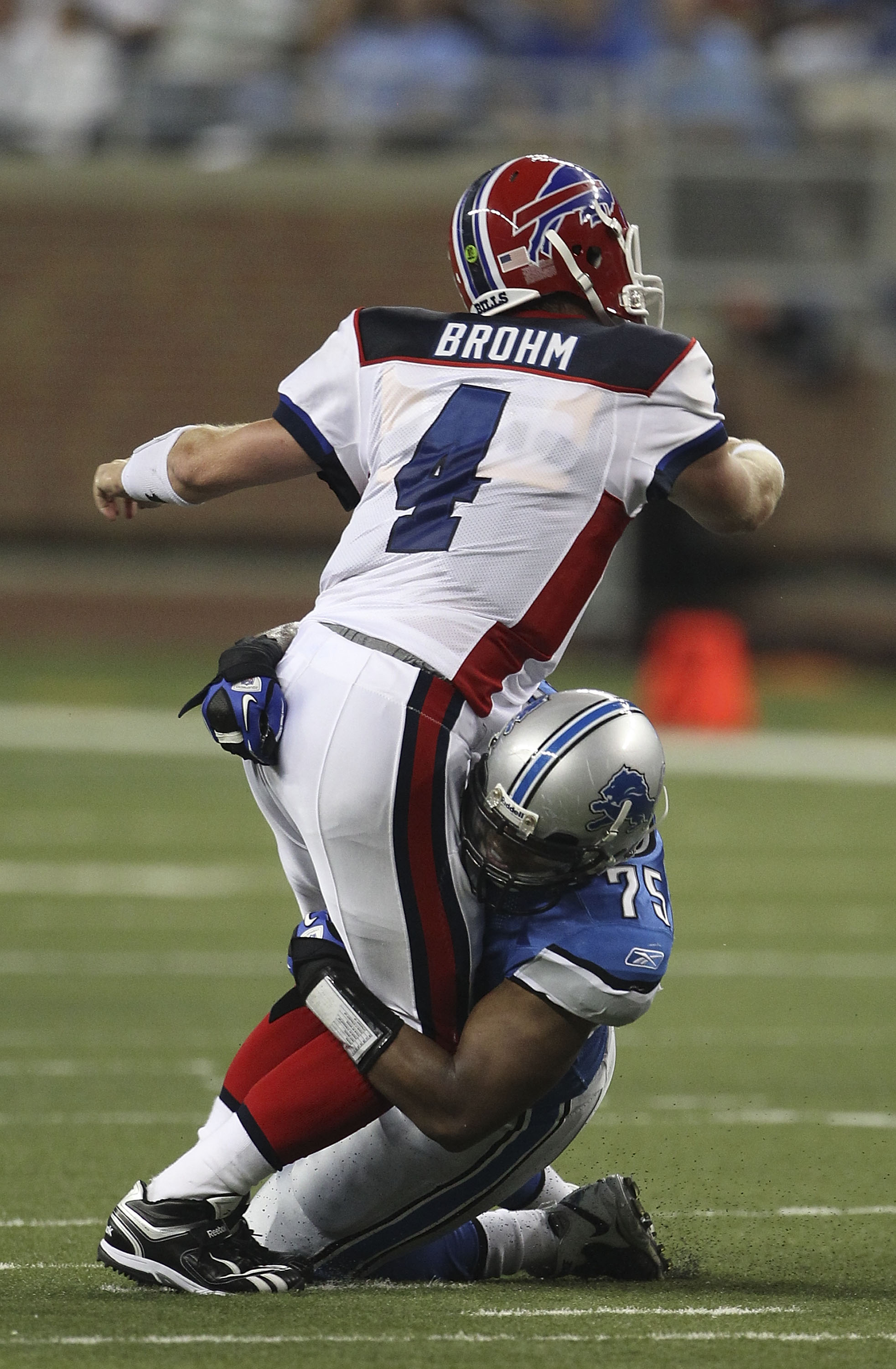 DETROIT - SEPTEMBER 02: Turk McBride #75 of the Detroit Lions sacks Brian Brohm #4 of the Buffalo Bills during the preseason game at Ford Field on September 2, 2010 in Detroit, Michigan.  (Photo by Leon Halip/Getty Images)