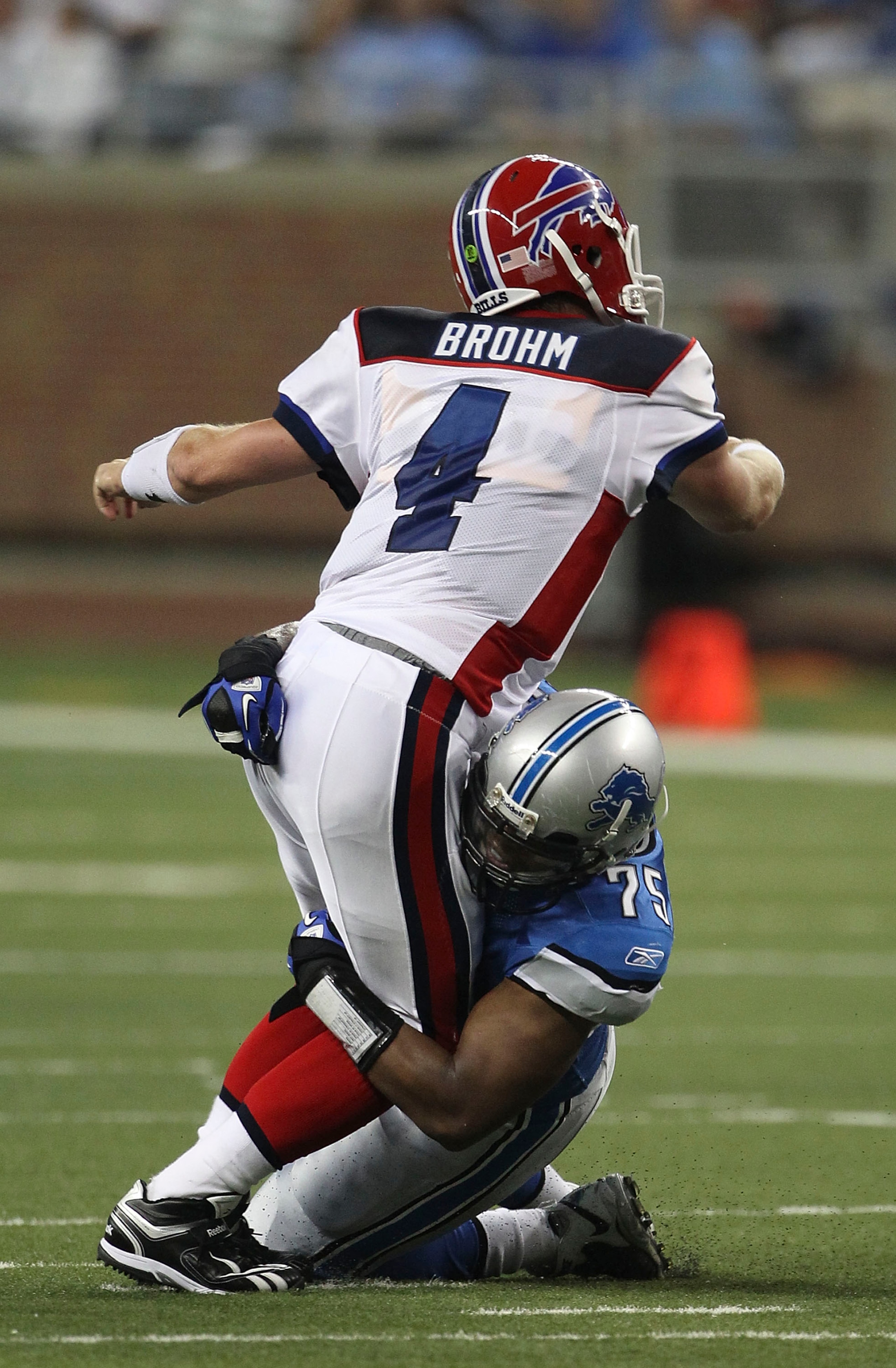 DETROIT - SEPTEMBER 02: Turk McBride #75 of the Detroit Lions sacks Brian Brohm #4 of the Buffalo Bills during the preseason game at Ford Field on September 2, 2010 in Detroit, Michigan.  (Photo by Leon Halip/Getty Images)