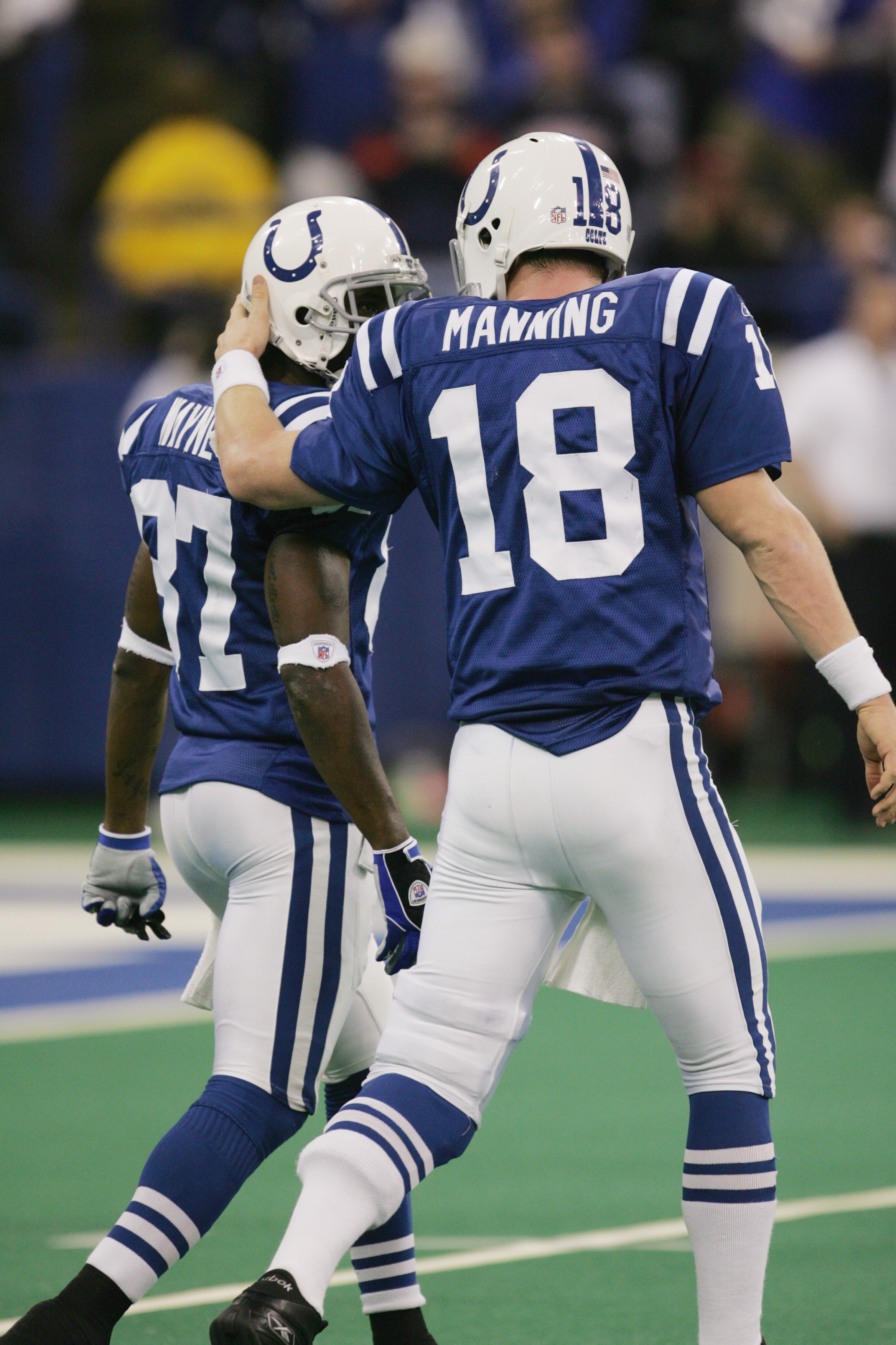 INDIANAPOLIS - DECEMBER 26:  Peyton Manning #18 of the Indianapolis Colts talks  to teammate Reggie Wayne #87 during the game against the San Diego Chargers on December 26, 2004 at the RCA Dome in Indianapolis, Indiana.  Peyton Manning passed Dan Marino a