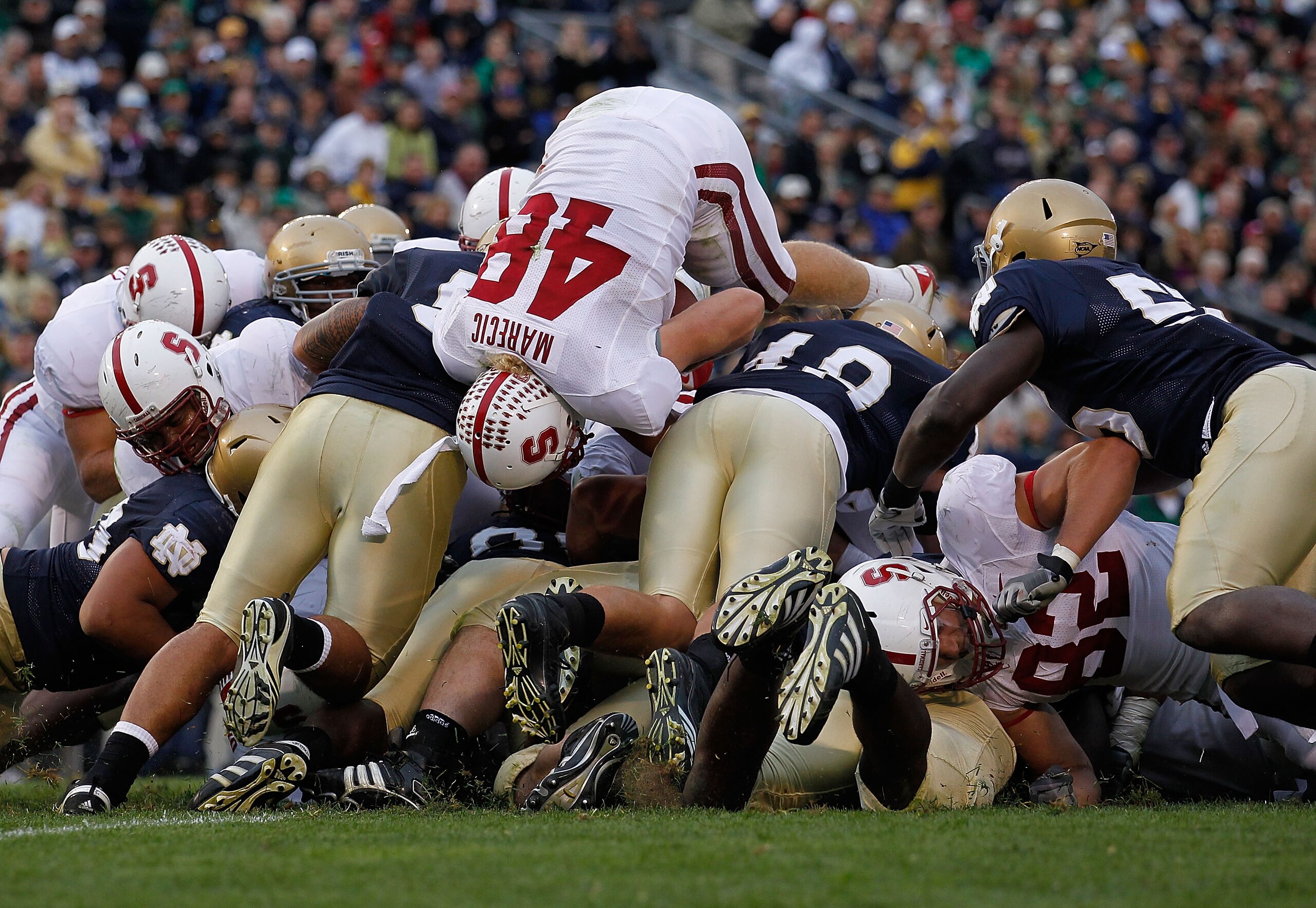 SOUTH BEND, IN - SEPTEMBER 25: Owen Marecic #48 of the Stanford Cardinal jumps over the line to score an offensive touchdown against the Notre Dame Fighting Irish at Notre Dame Stadium on September 25, 2010 in South Bend, Indiana. Stanford defeated Notre 