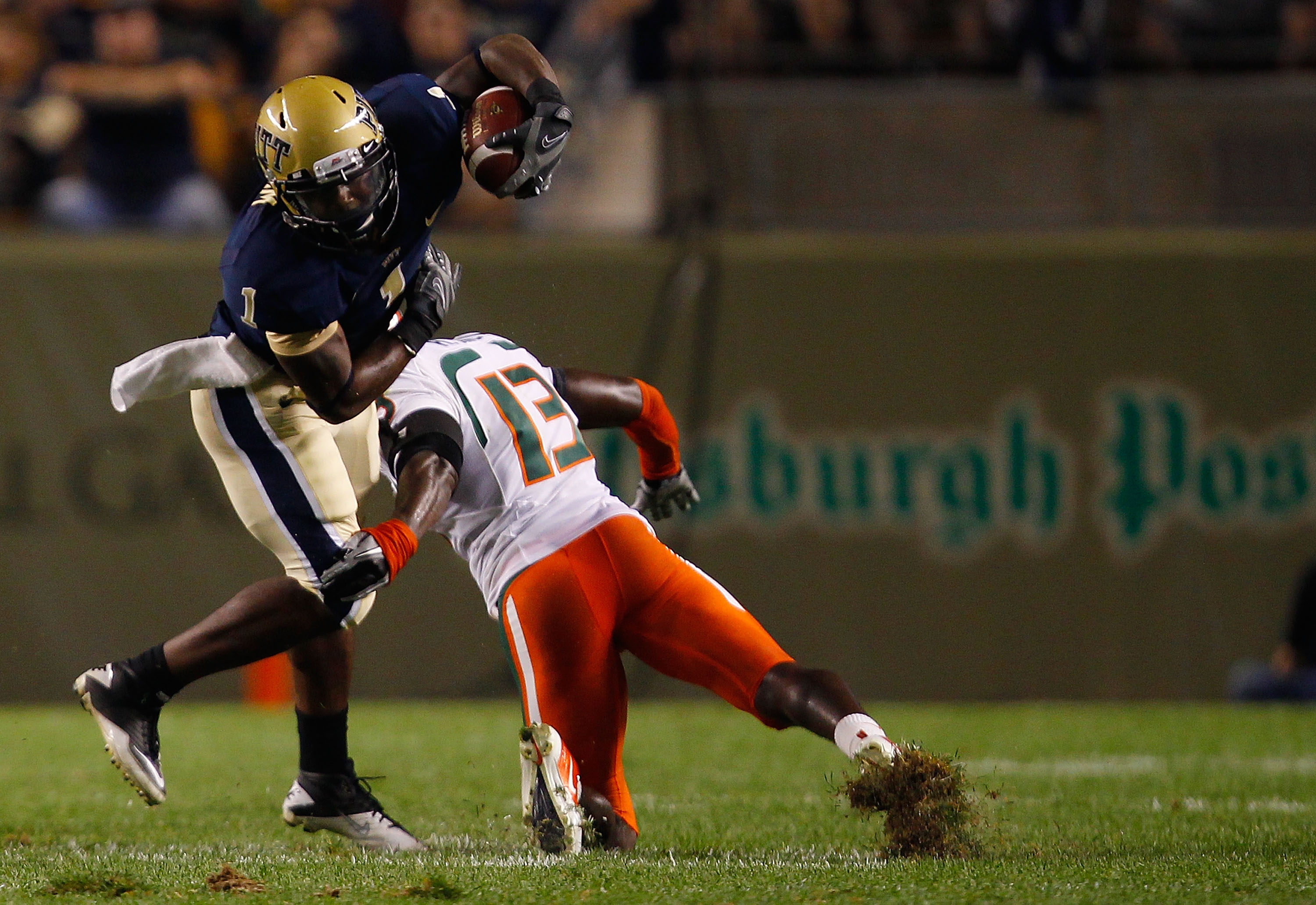 PITTSBURGH - SEPTEMBER 23:  Ray Graham #1 of the Pittsburgh Panthers evades a tackle by Ryan Hill #13 of the Miami Hurricanes on September 23, 2010 at Heinz Field in Pittsburgh, Pennsylvania.  (Photo by Jared Wickerham/Getty Images)