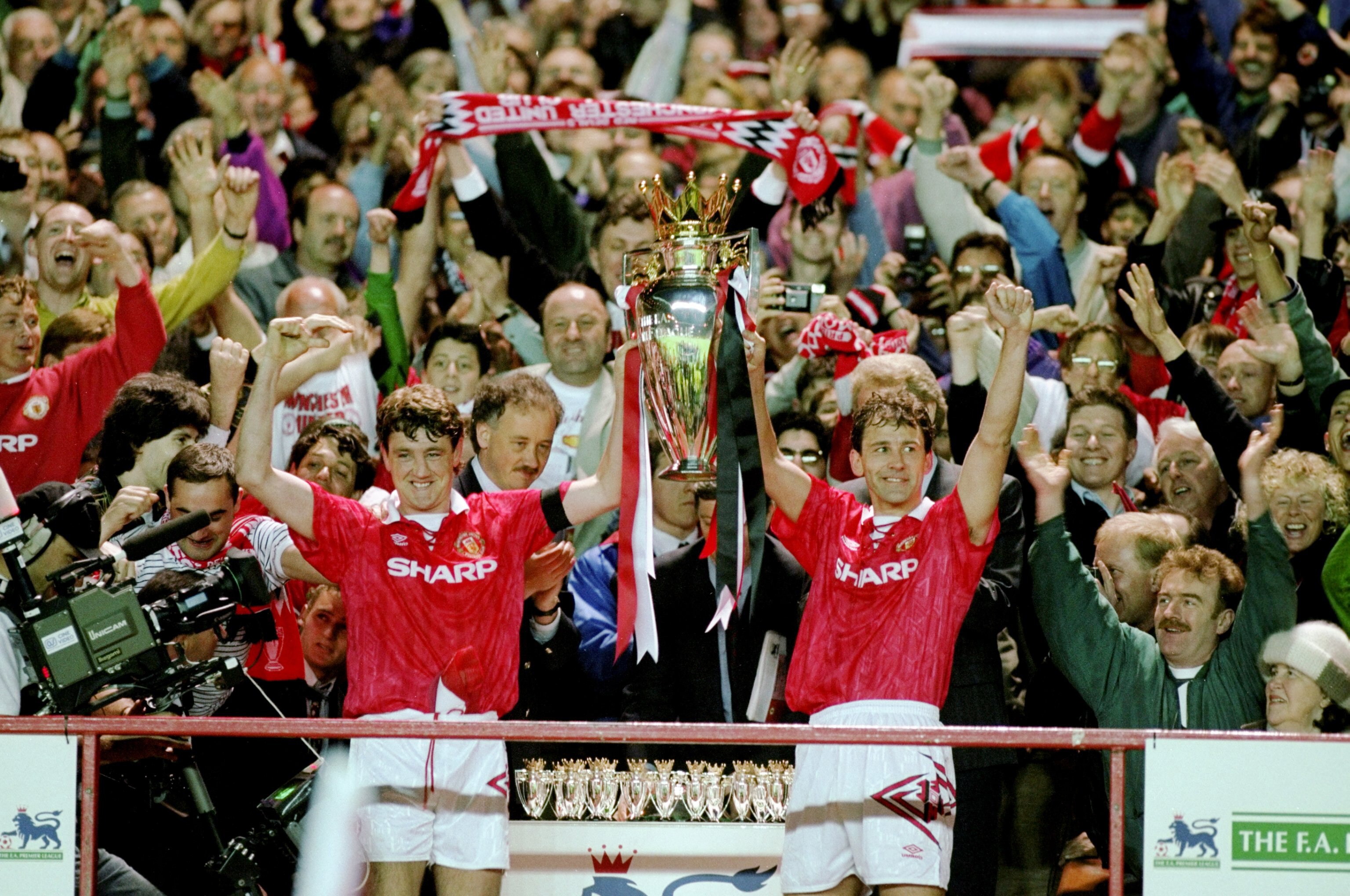 8 May 1993:  Steve Bruce and Bryan Robson of Manchester United celebrate with the premiership trophy after clinching the title during the FA Carling Premiership match against Coventry City played at Old Trafford in Manchester, England. \ Mandatory Credit: