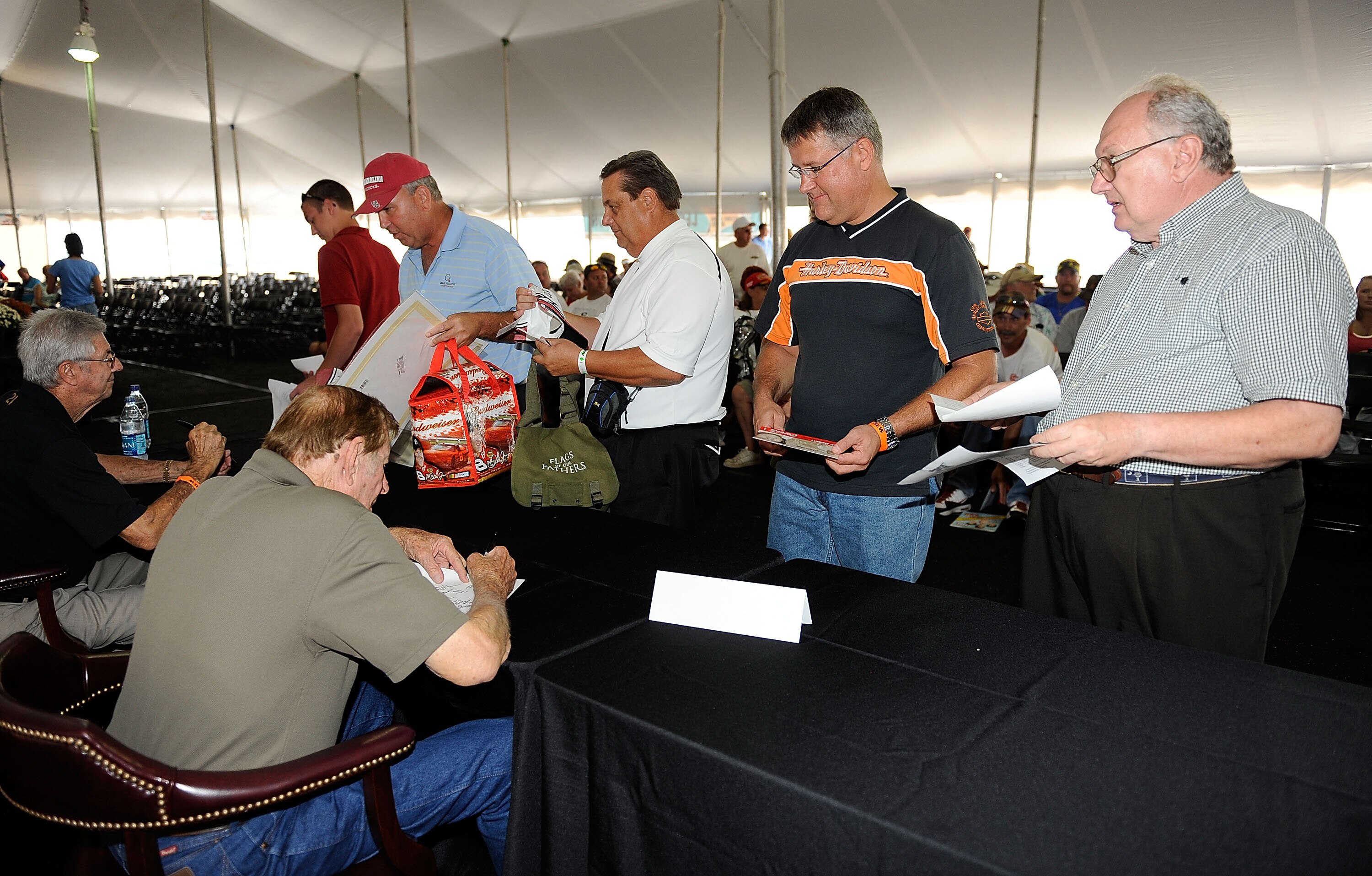 DARLINGTON, SC - SEPTEMBER 25:  NASCAR Legend Bud Moore signs autographs during the Darlington Historic Racing Festival at Darlington Raceway on September 25, 2010 in Darlington, South Carolina.  (Photo by Rusty Jarrett/Getty Images)