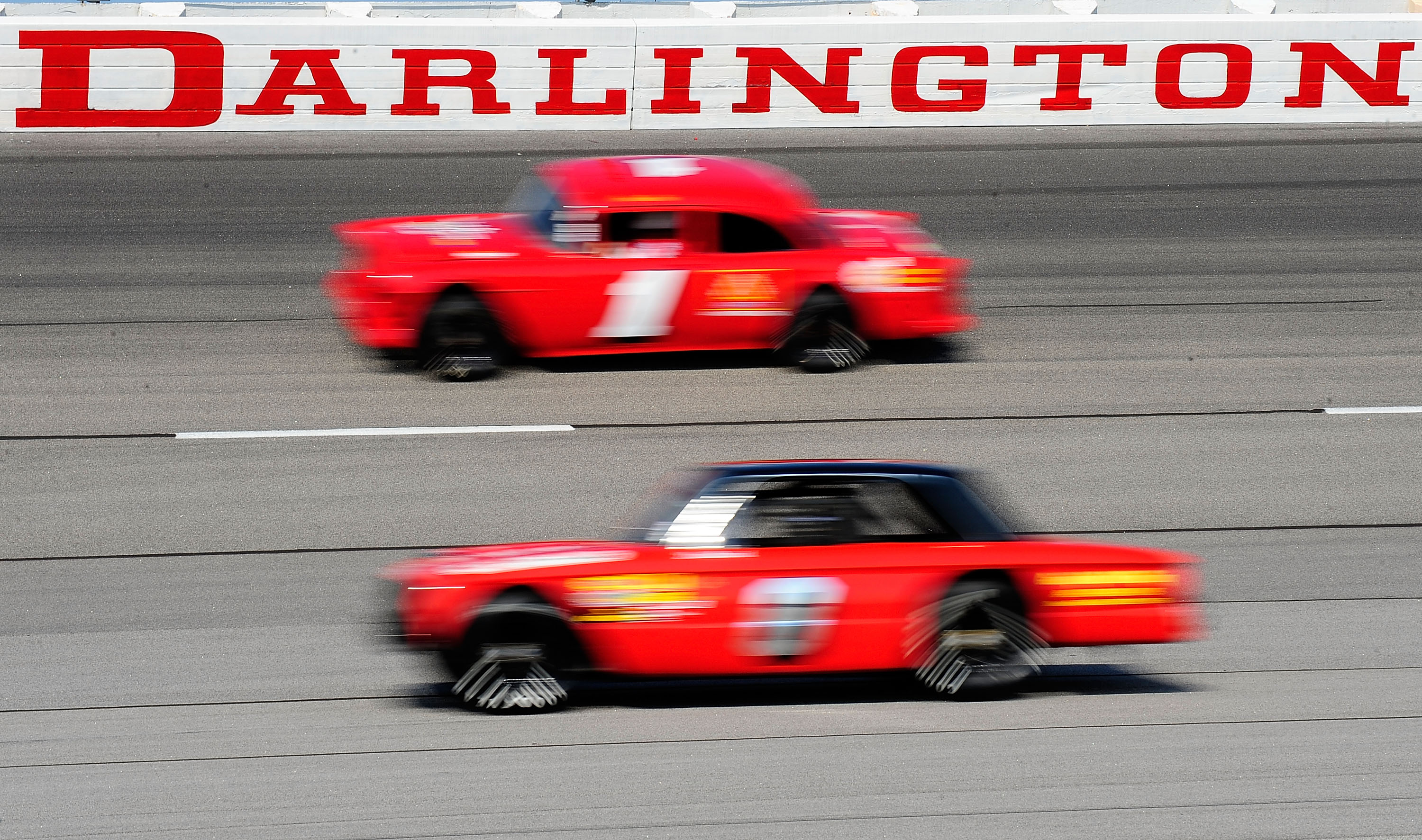 DARLINGTON, SC - SEPTEMBER 25:  Vintage stock cars drive through turn three during the Darlington Historic Racing Festival at Darlington Raceway on September 25, 2010 in Darlington, South Carolina.  (Photo by Rusty Jarrett/Getty Images)