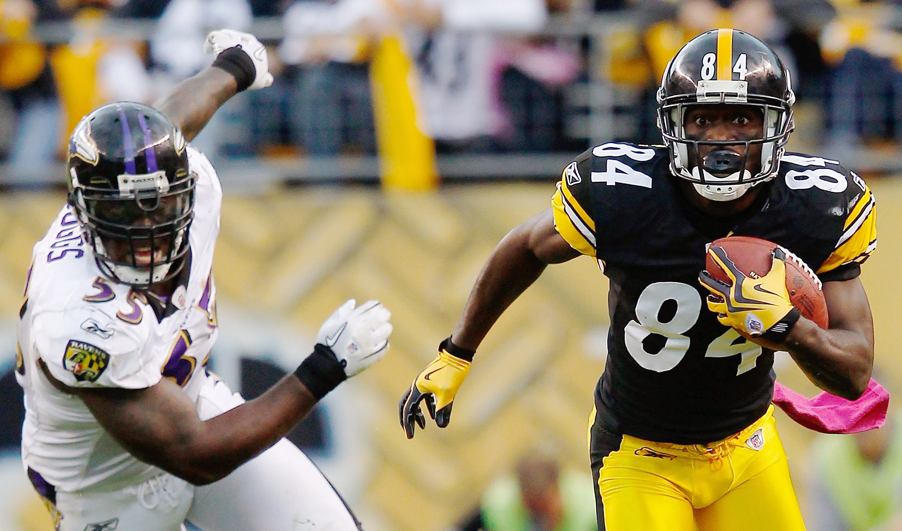 PITTSBURGH - OCTOBER 03:  Antonio Brown #84 of the Pittsburgh Steelers runs with the ball past Terrell Suggs #55 of the Baltimore Ravens during the game on October 3, 2010 at Heinz Field in Pittsburgh, Pennsylvania.  (Photo by Jared Wickerham/Getty Images