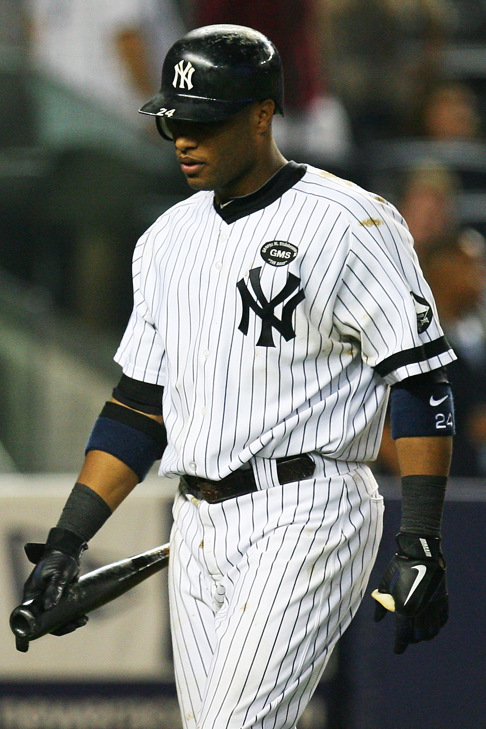 NEW YORK - SEPTEMBER 24: Robinson Cano #24 of the New York Yankees walks back to the dug out after striking out swinging in the ninth inning against the Boston Red Sox on September 24, 2010 at Yankee Stadium in the Bronx borough of New York City.  The Red