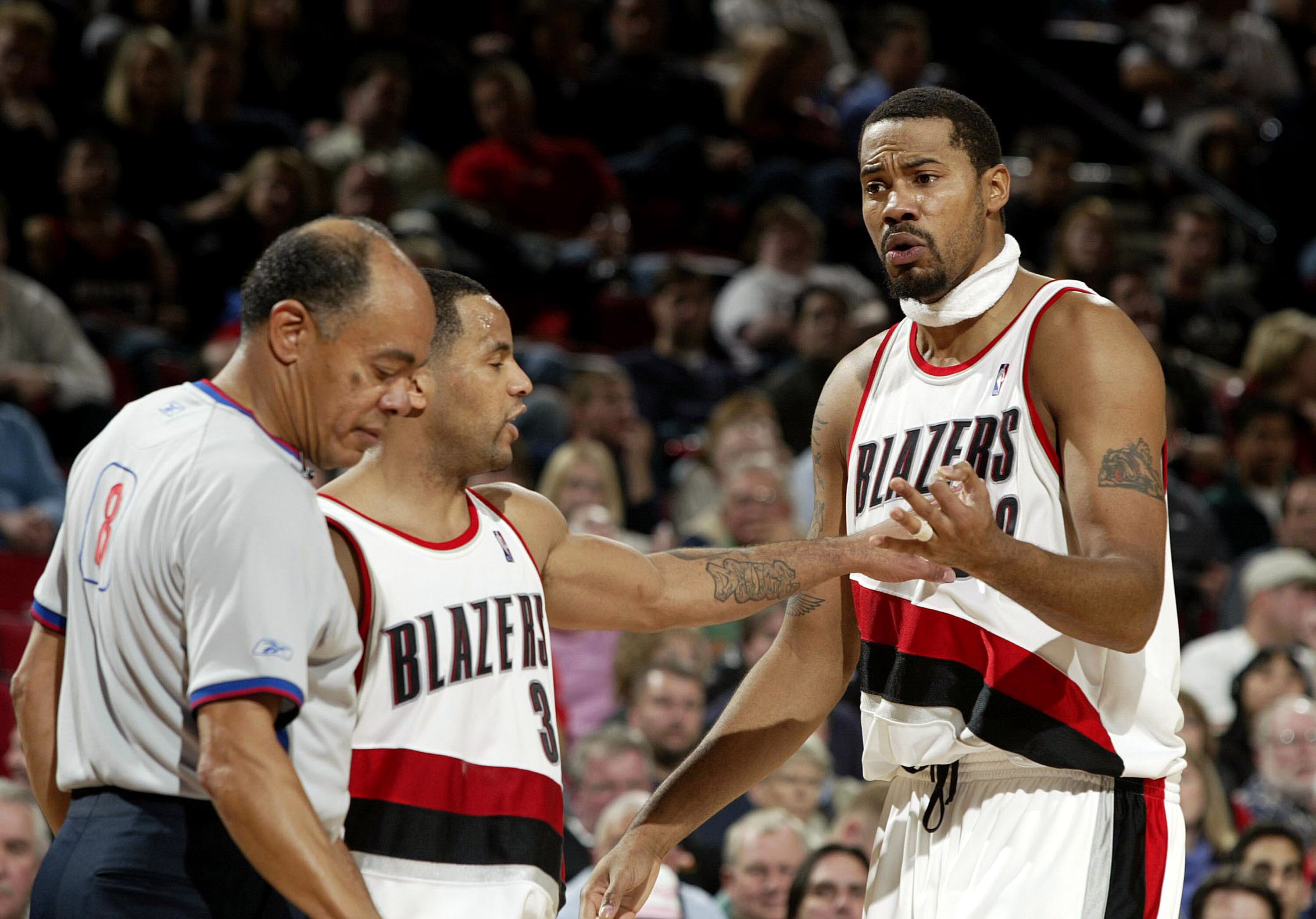 PORTLAND, OR - NOVEMBER 13:  Rasheed Wallace #30 of the Portland Trail Blazers argues with the referee as teammate Damon Stoudamire #3 holds him back during a NBA game against the Sacramento Kings November 13, 2003 at the Rose Garden in Portland, Oregon.