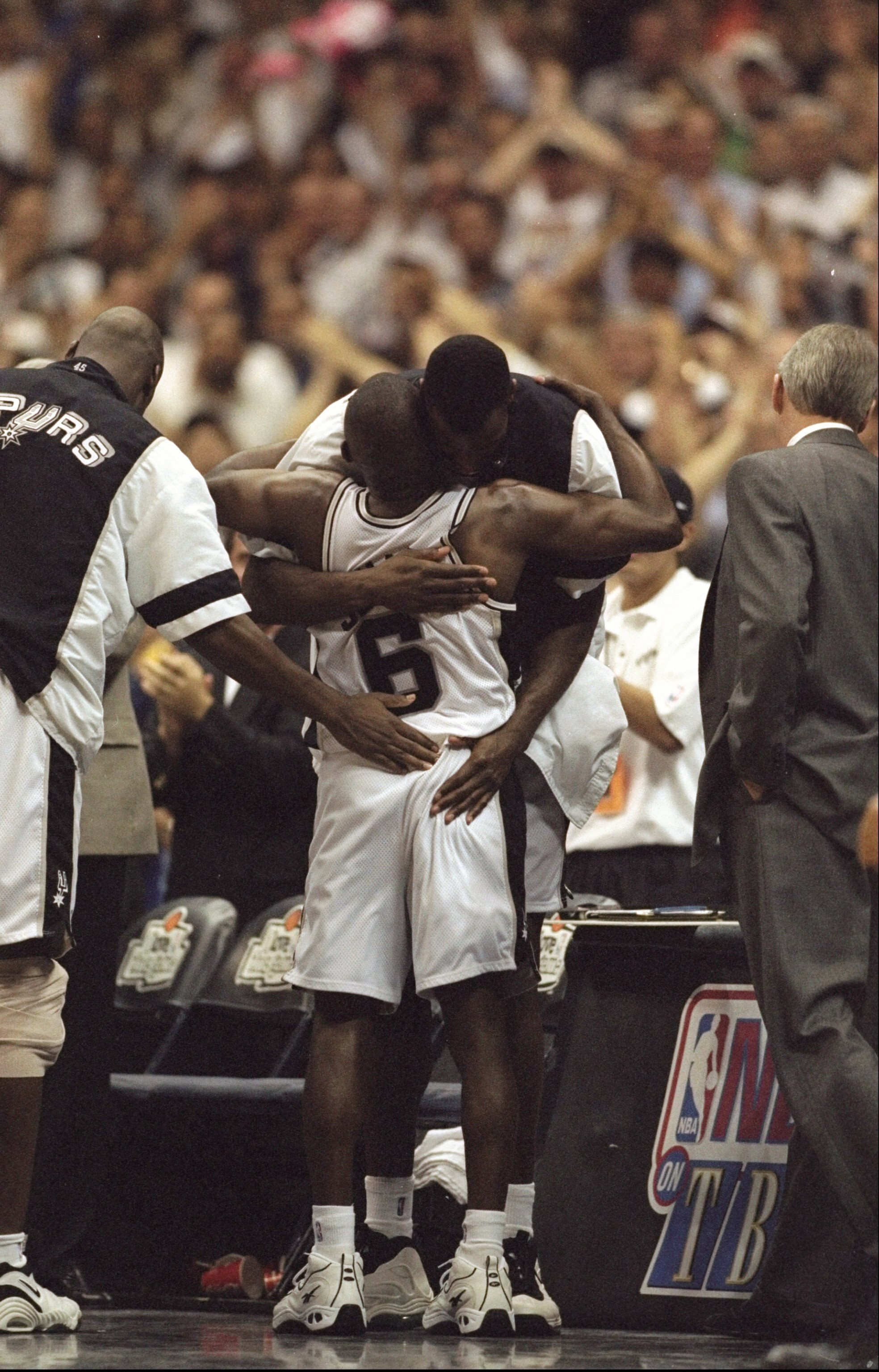 29 Apr 1998: David Robinson hugs teammate Avery Johnson #6 of the Atlanta Spurs during the NBA Western Conference Playoffs round 1 game against the Atlanta Spurs at the Alamo Dome in San Antonio, Texas. The Spurs defeated the Suns 99-80.