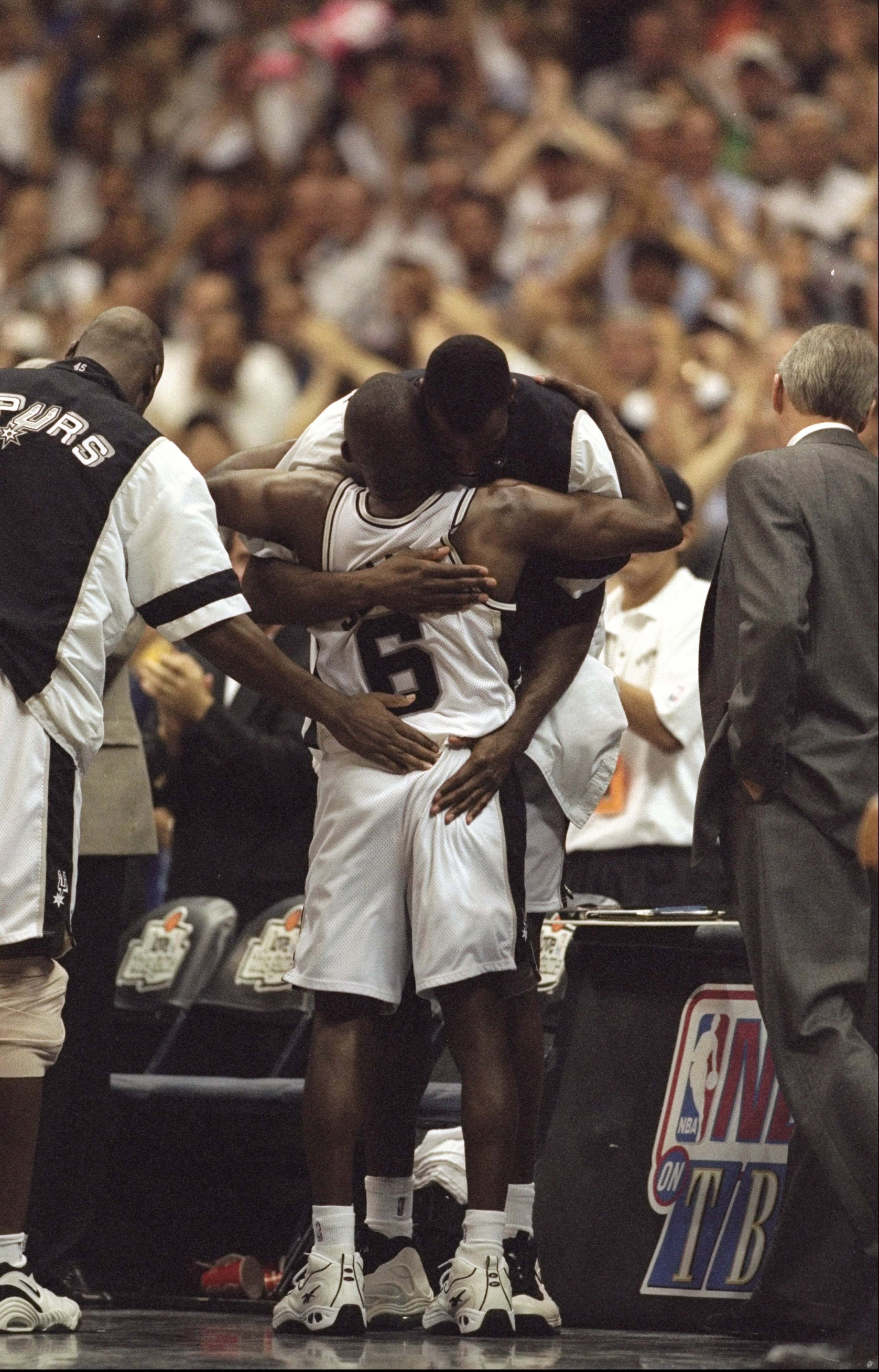 29 Apr 1998: David Robinson hugs teammate Avery Johnson #6 of the Atlanta Spurs during the NBA Western Conference Playoffs round 1 game against the Atlanta Spurs at the Alamo Dome in San Antonio, Texas. The Spurs defeated the Suns 99-80.