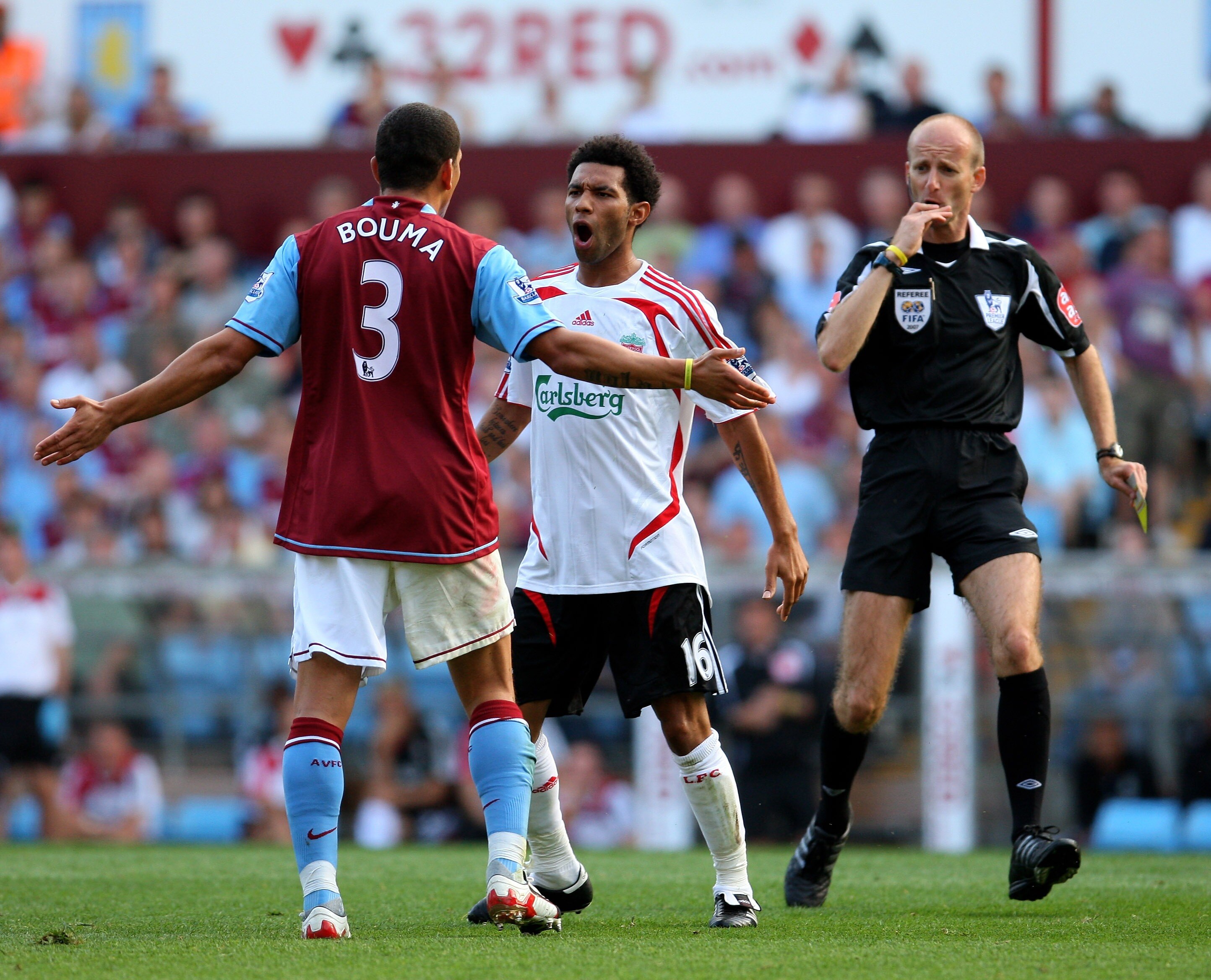 BIRMINGHAM, UNITED KINGDOM - AUGUST 11: Referee Mike Riley prepares to step in between Liverpool striker Jermaine Pennant and Villa defender Wilfred Bouma during the Barclays Premier League Match between Aston Villa and Liverpool at Villa Park on August 1