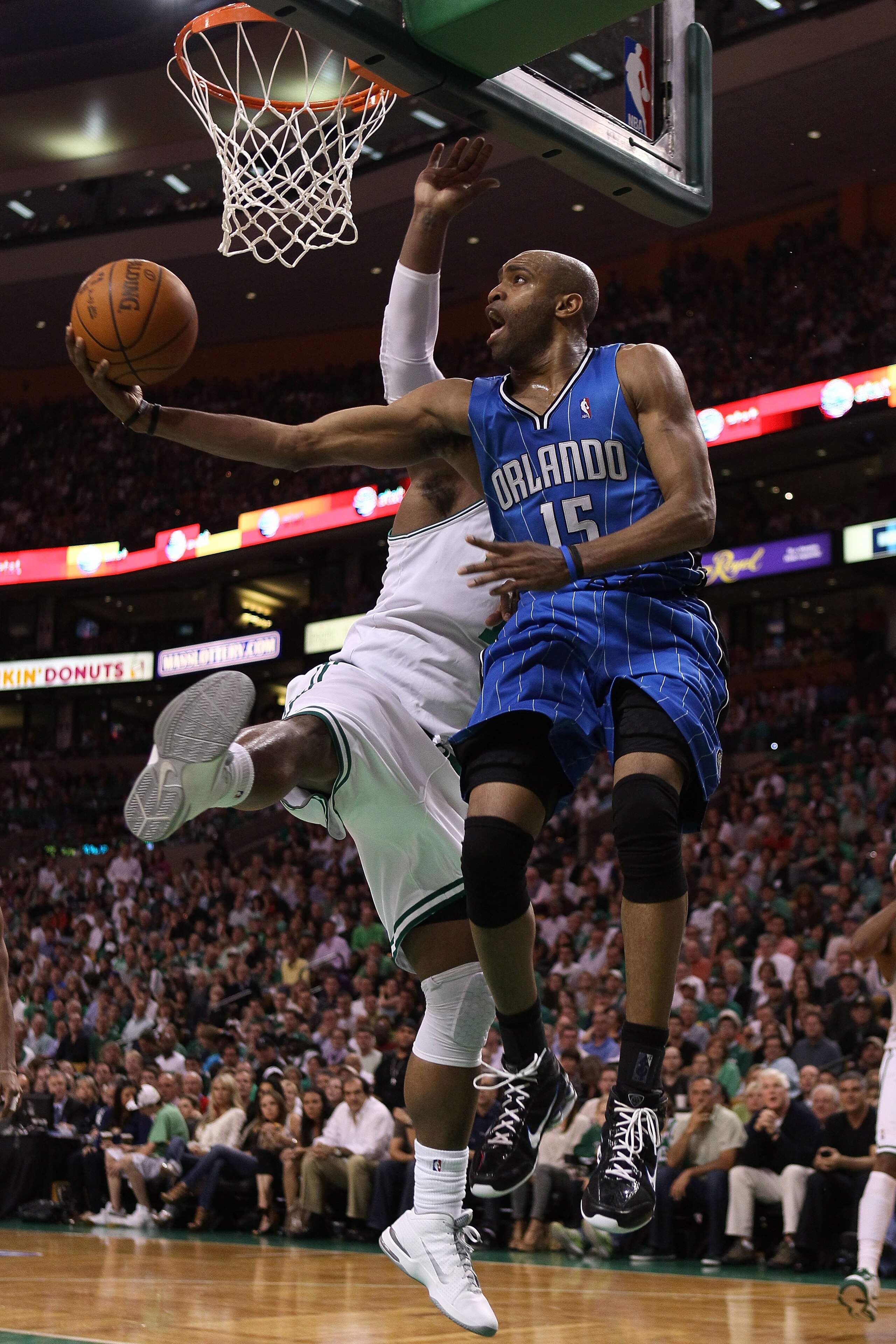 BOSTON - MAY 22:  Vince Carter #15 of the Orlando Magic drives for a shot attempt against Glen Davis #11 of the Boston Celtics at TD Banknorth Garden in Game Three of the Eastern Conference Finals during the 2010 NBA Playoffs on May 22, 2010 in Boston, Ma