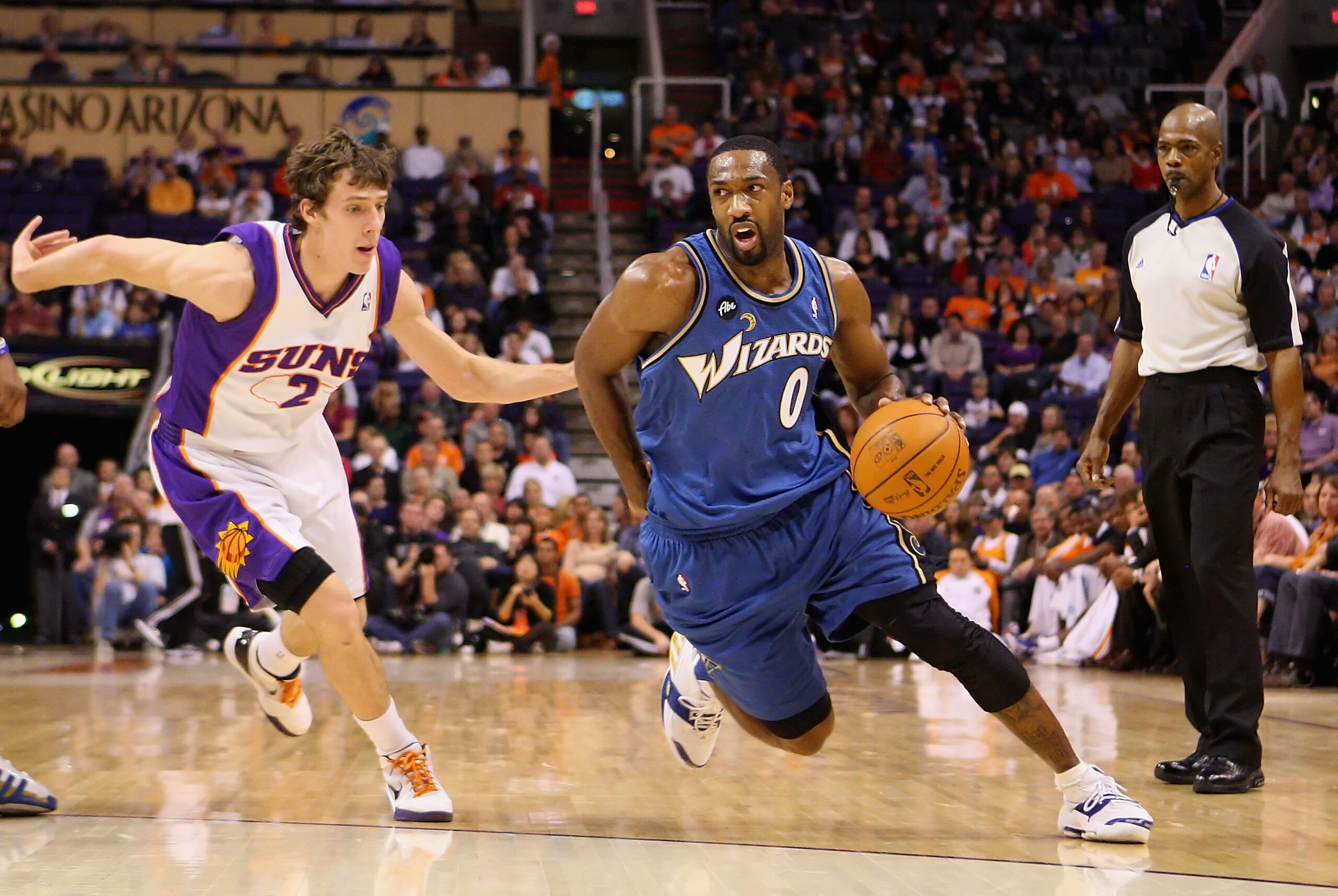 PHOENIX - DECEMBER 19:  Gilbert Arenas #0 of the Washington Wizards drives the ball past Goran Dragic #2 of the Phoenix Suns during the NBA game at US Airways Center on December 19, 2009 in Phoenix, Arizona. The Suns defeated the Wizards 121-95.  NOTE TO