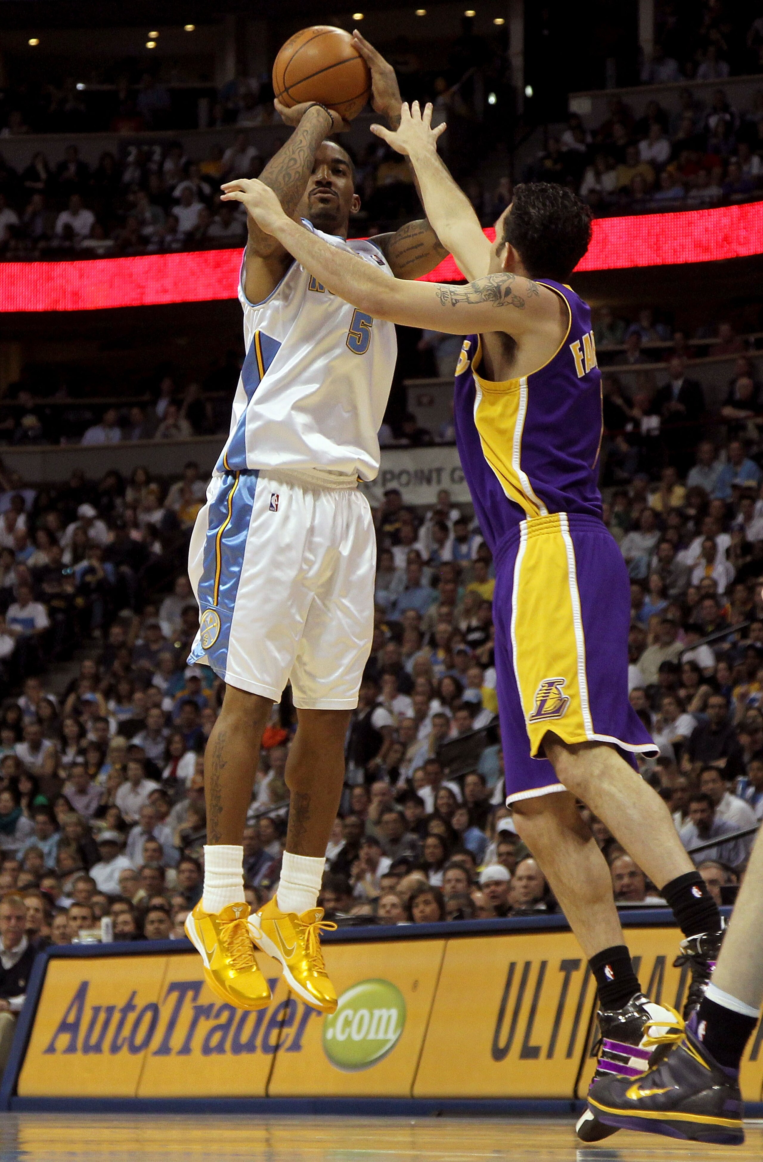 DENVER - APRIL 08:  J.R. Smith #5 of the Denver Nuggets takes a shot over Jordan Farmer #1 of the Los Angeles Lakers during NBA action at the Pepsi Center on April 8, 2010 in Denver, Colorado. The Nuggets defeated the Lakers 98-96. NOTE TO USER: User expr