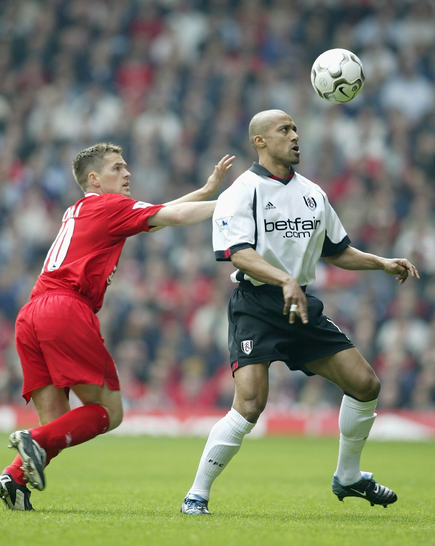 LIVERPOOL, ENGLAND - APRIL 12:  Michael Owen of Liverpool battles with Steve Marlet of Fulham during the FA Barclaycard Premiership match between Liverpool and Fulham at Anfield on April12, 2003, in Liverpool, England. (Photo by Mark Thompson/Getty Images