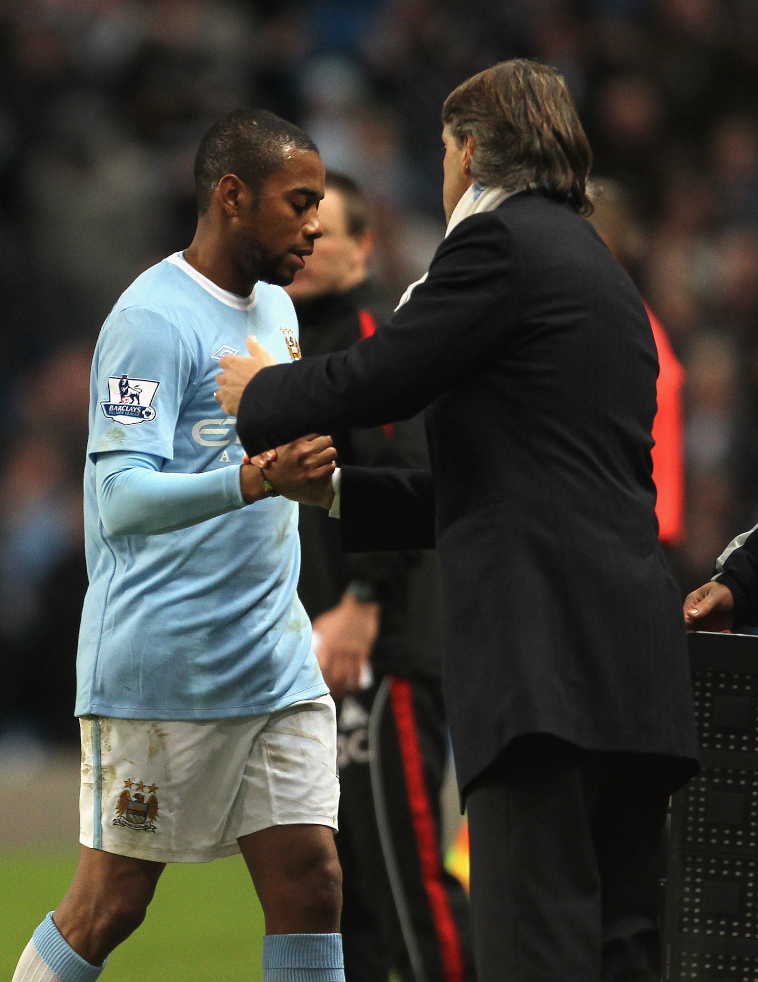 MANCHESTER, ENGLAND - DECEMBER 26:  Robinho of Manchester City is substituted by Roberto Mancini, the manager of Manchester City, during the Barclays  Premier League match between Manchester City and Stoke City at City of Manchester Stadium on December 26