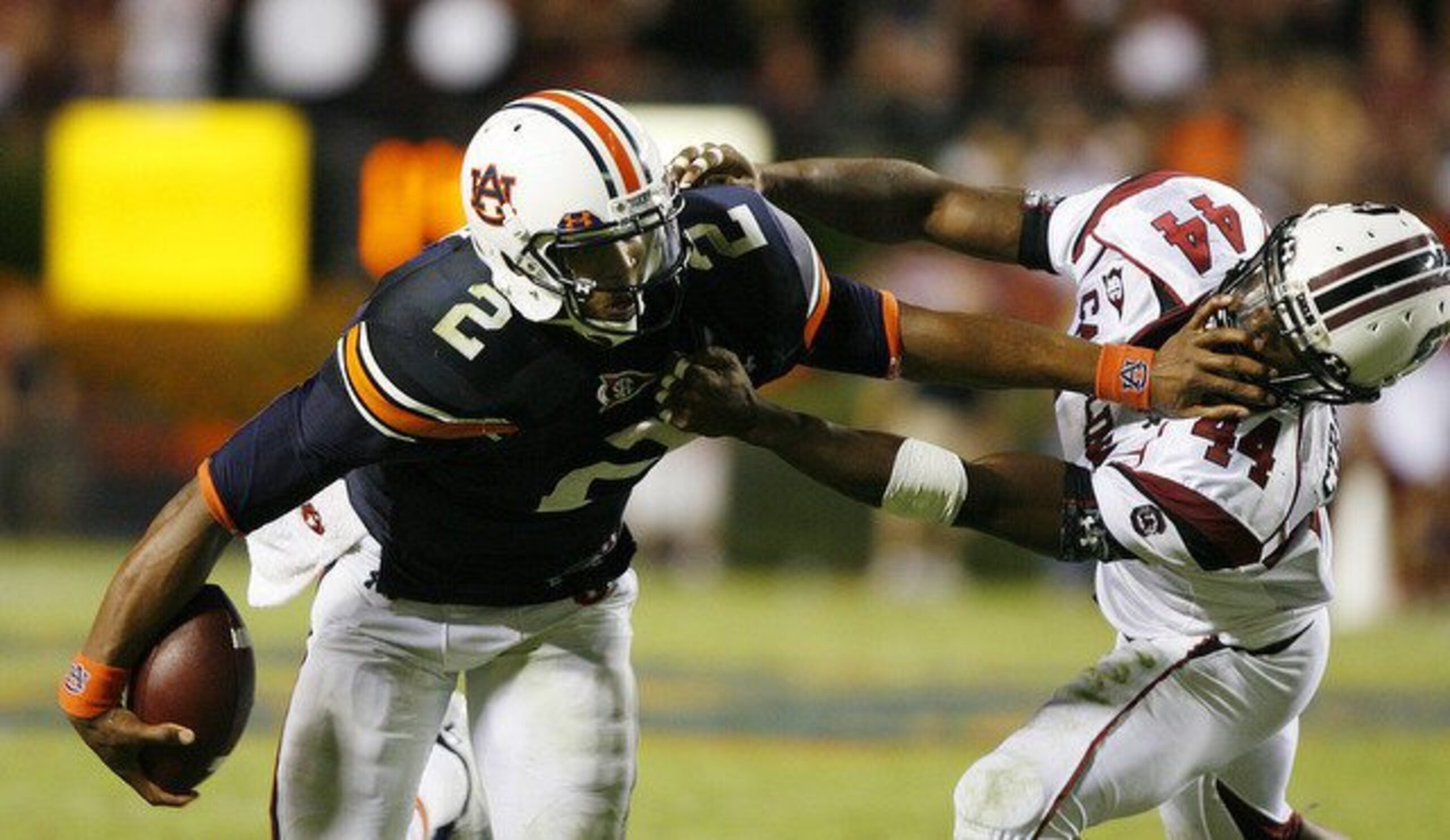 Cam Newton delivers a stiff arm to a South Carolina defender