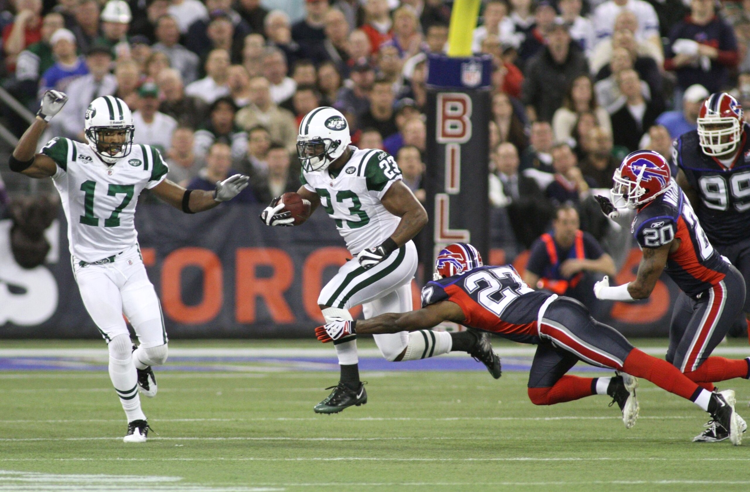 TORONTO - DECEMBER 3: Shonn Greene #23 of the New York Jets runs the ball against Reggie Corner #27 of the Buffalo Bills at Rogers Centre on December 3, 2009 in Toronto, Canada.  (Photo by Rick Stewart/Getty Images)
