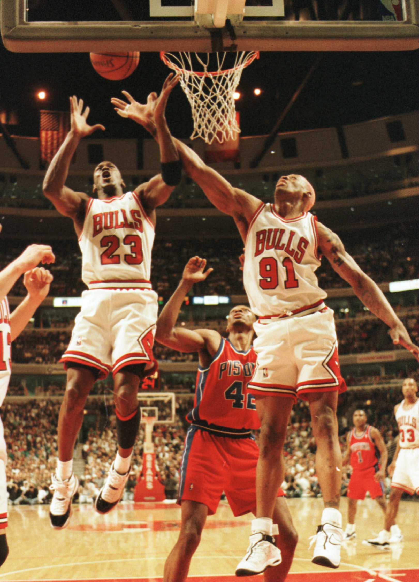 18 Apr 1996:  Forwards Michael Jordan #23 and Dennis Rodman #91 of the Chicago Bulls reach for a defensive rebound over Center Theo Ratliff of the Detroit Pistons during first quarter action of their game at the United Center in Chicago, Illinois. Mandato