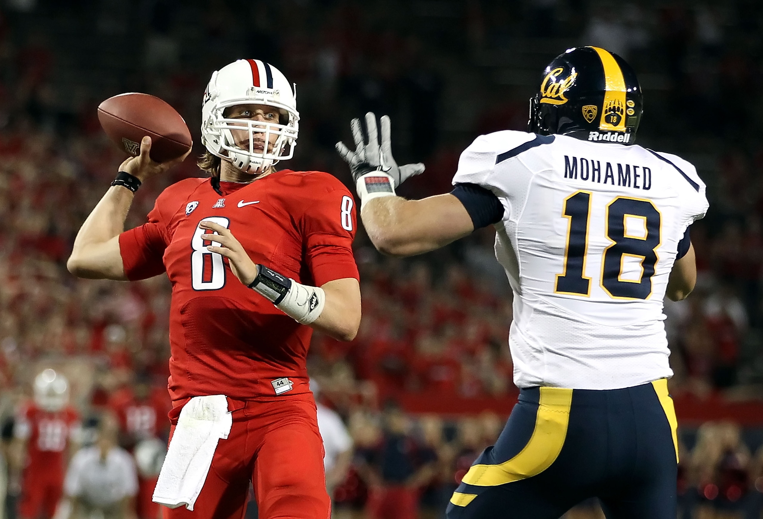 TUCSON, AZ - SEPTEMBER 25: Quarterback Nick Foles #8 of the Arizona Wildcats throws the game winning touchdown under pressure from Michael Mohamed #18 of the California Golden Bears in the fourth quarter of the college football game at Arizona Stadium on TUCSON, AZ - SEPTEMBER 25: Quarterback Nick Foles #8 of the Arizona Wildcats throws the game winning touchdown under pressure from Michael Mohamed #18 of the California Golden Bears in the fourth quarter of the college football game at Arizona Stadium on