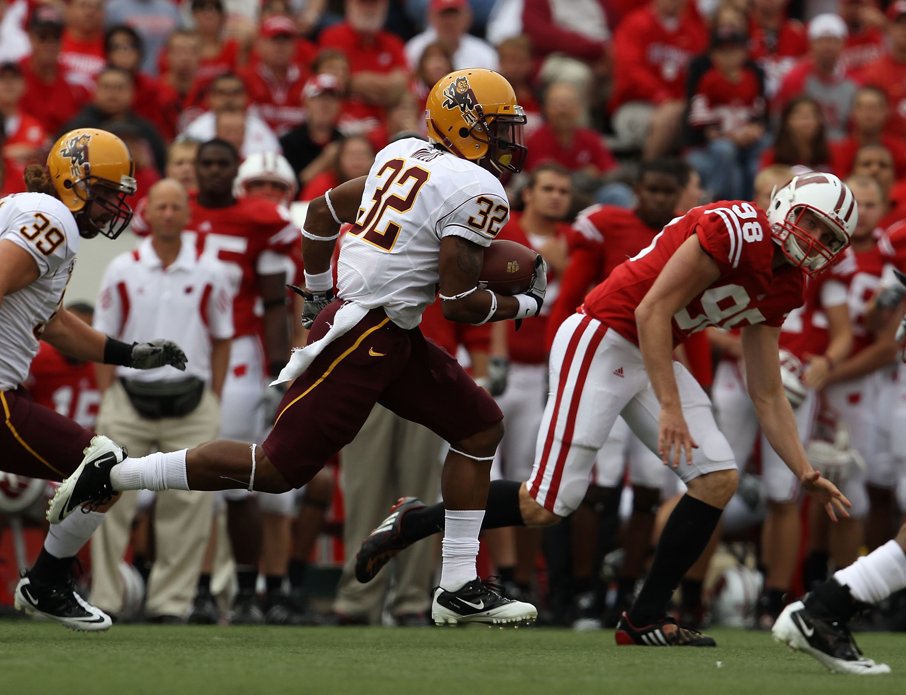 MADISON, WI - SEPTEMBER 18: Jamal Miles #32 of the Arizona State Sun Devils returns a kick as Brad Nortman #98 of the Wisconsin Badgers gives chase at Camp Randall Stadium on September 18, 2010 in Madison, Wisconsin. Wisconsin defeated Arizona State 20-19