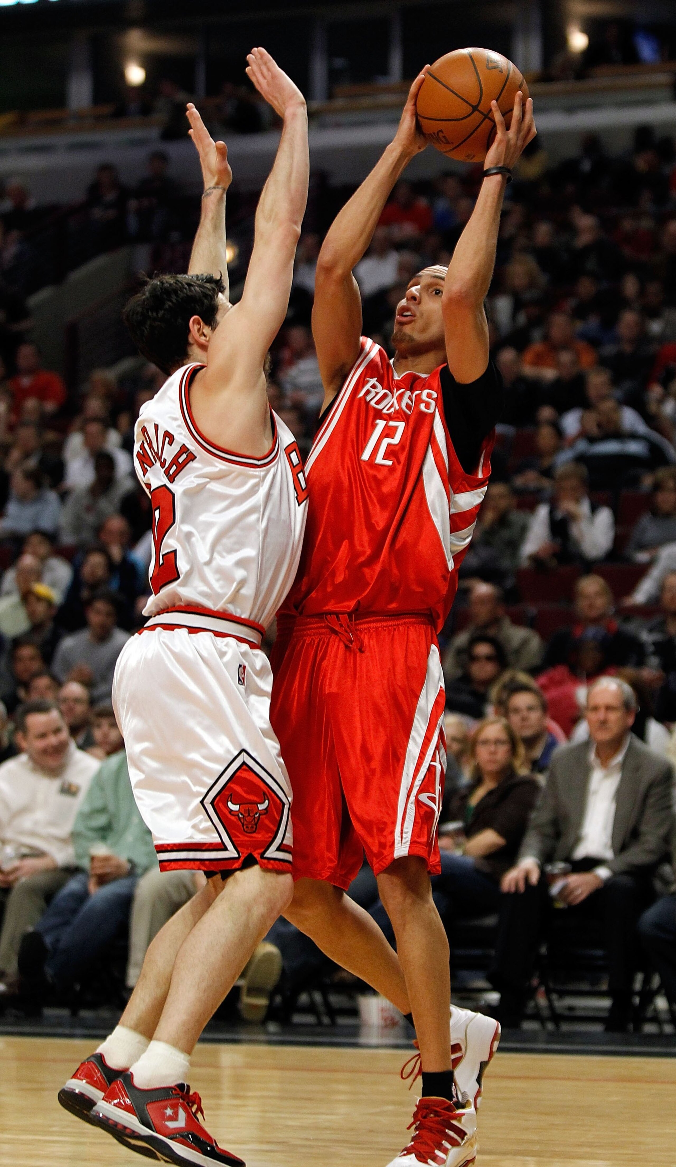 CHICAGO - MARCH 22: Kevin Martin #12 of the Houston Rockets puts up a shot and is fouled by Kirk Hinrich #12 of the Chicago Bulls at the United Center on March 22, 2010 in Chicago, Illinois. The Bulls defeated the Rockets 98-88. NOTE TO USER: User express