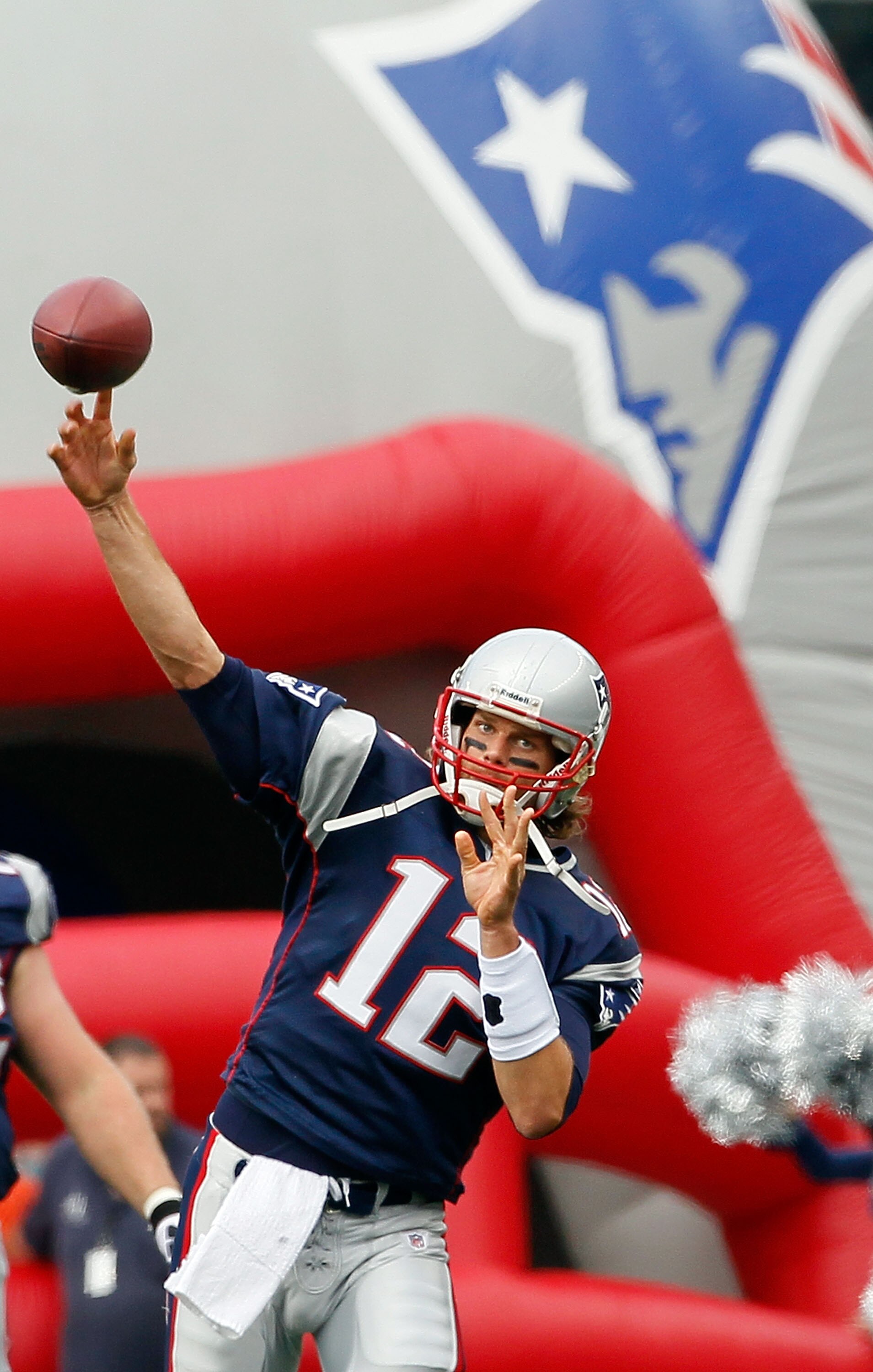 FOXBORO, MA - SEPTEMBER 26:  Tom Brady #12 of the New England Patriots throws on the sideine before a against the Buffalo Bills at Gillette Stadium on September 26, 2010 in Foxboro, Massachusetts. (Photo by Jim Rogash/Getty Images)