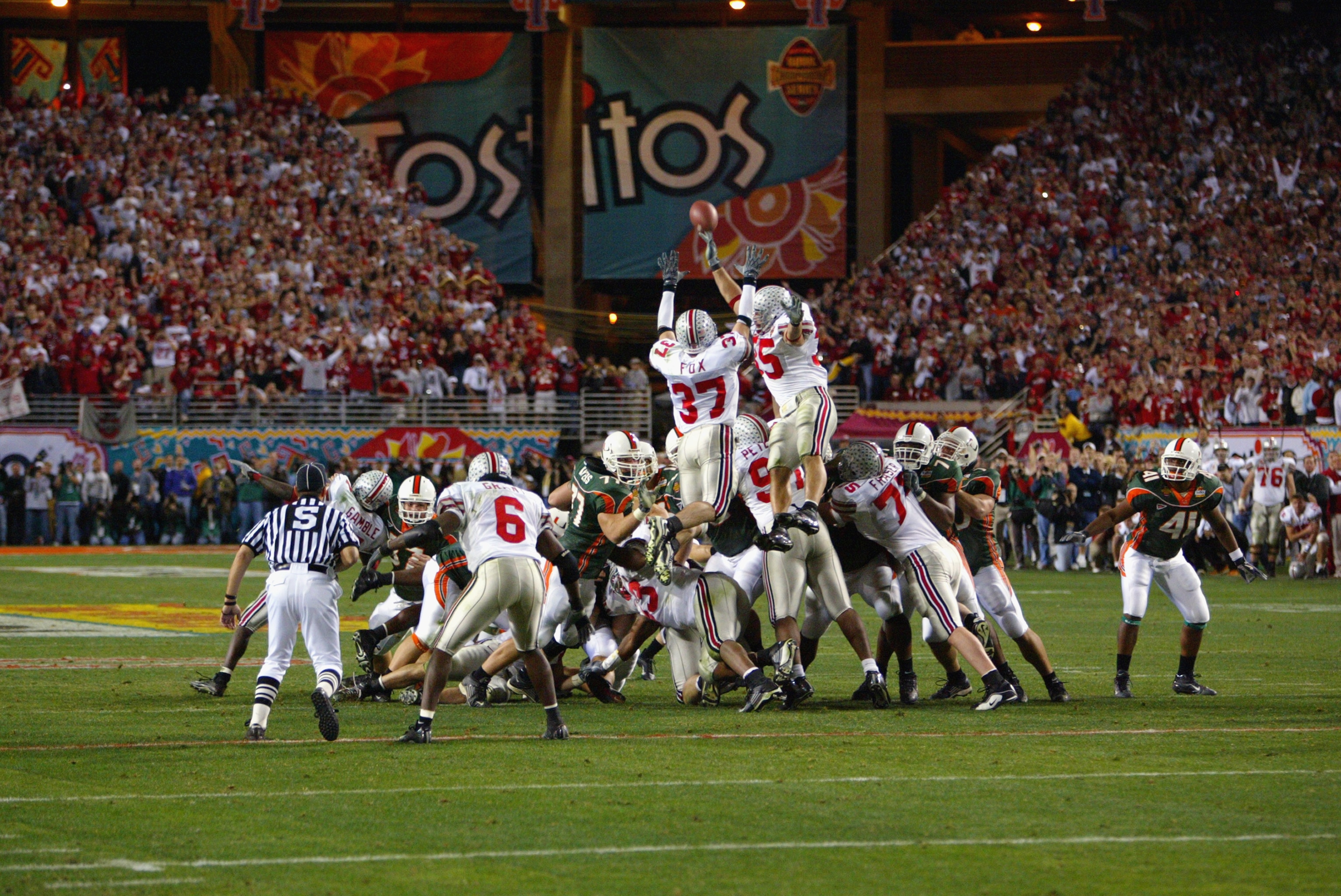 TEMPE, AZ - JANUARY 3:  Cornerback Dustin Fox #37 and Linebacker Matt Wilhelm #35 of the Ohio State Buckeyes go high to try and block a field goal against the Miami Hurricanes in the Tostitos Fiesta Bowl on January 3, 2003 at Sun Devil Stadium in Tempe, A