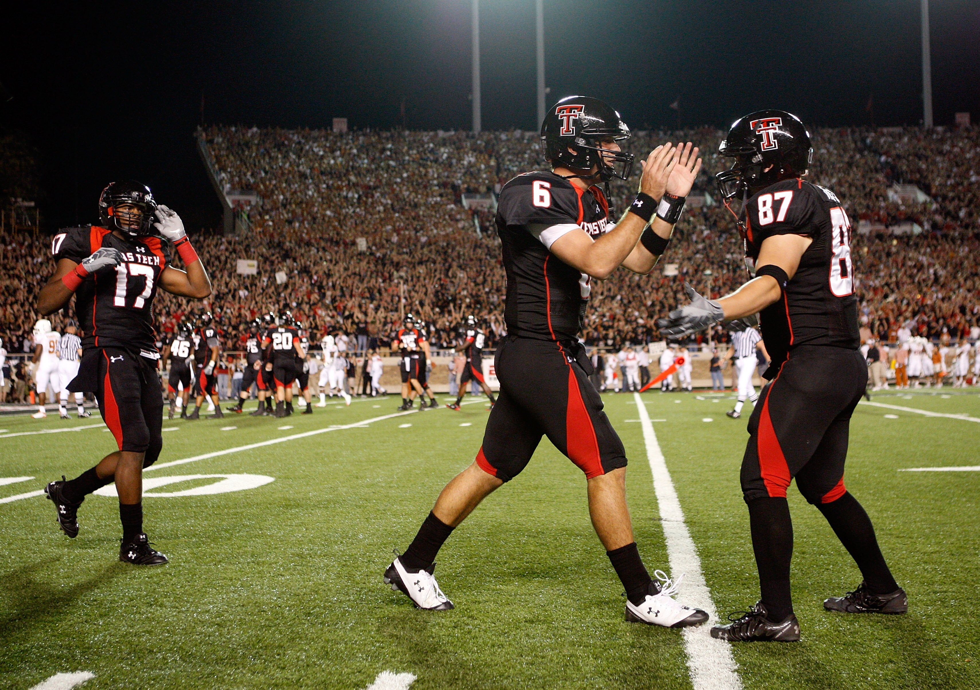 LUBBOCK, TX - NOVEMBER 01:  Quarterback Graham Harrell #6 of the Texas Tech Red Raiders is congratulated by teammates after the Raiders scored a touchdown during the first half of the game against the Texas Longhorns on November 1, 2008 at Jones Stadium i