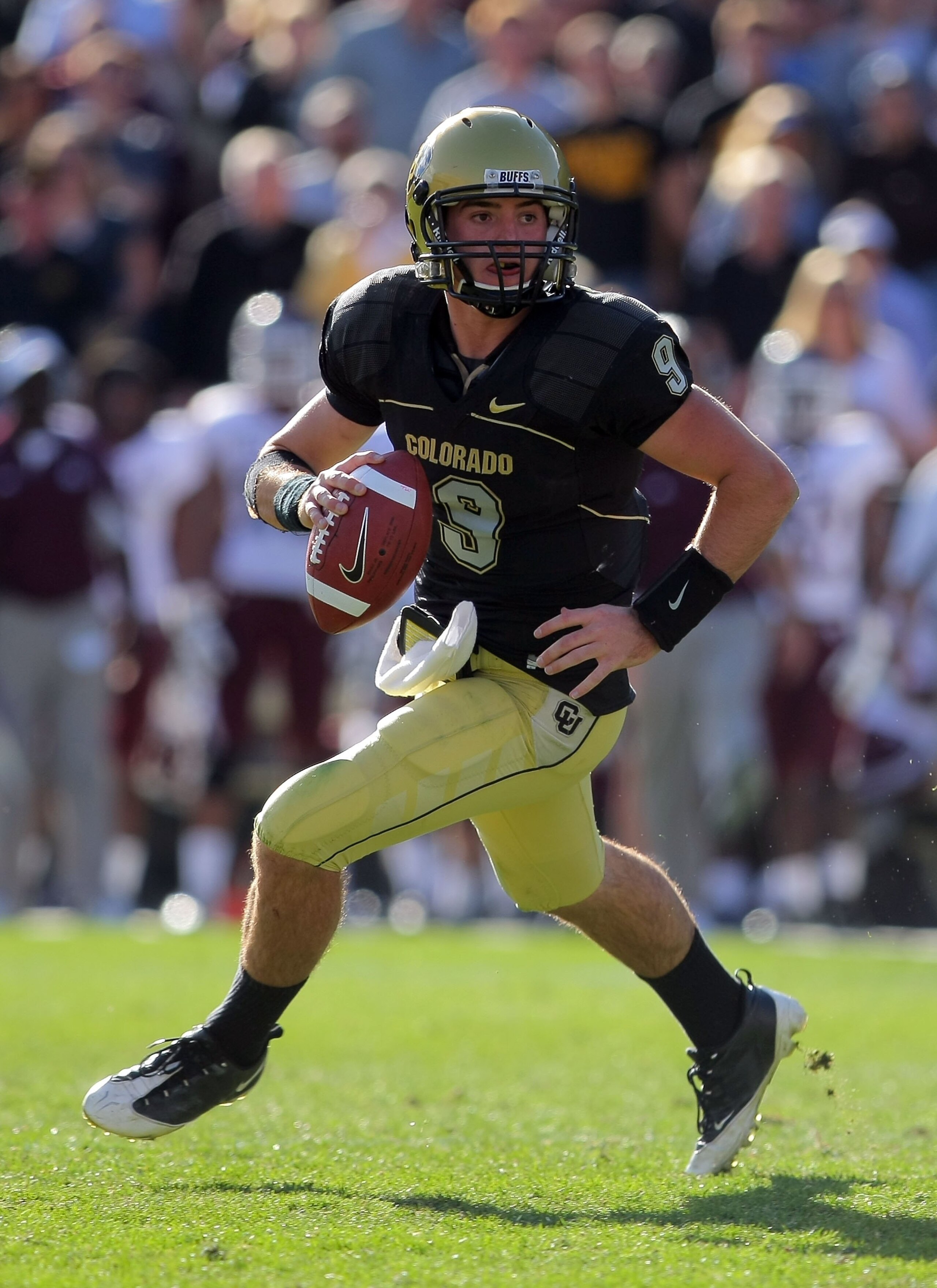BOULDER, CO - NOVEMBER 07:  Quarterback Tyler Hansen #9 of the Colorado Buffaloes rolls out to deliver a pass against the Texas A&M Aggies during NCAA college football action at Folsom Field on November 7, 2009 in Boulder, Colorado. Colorado defeated Texa