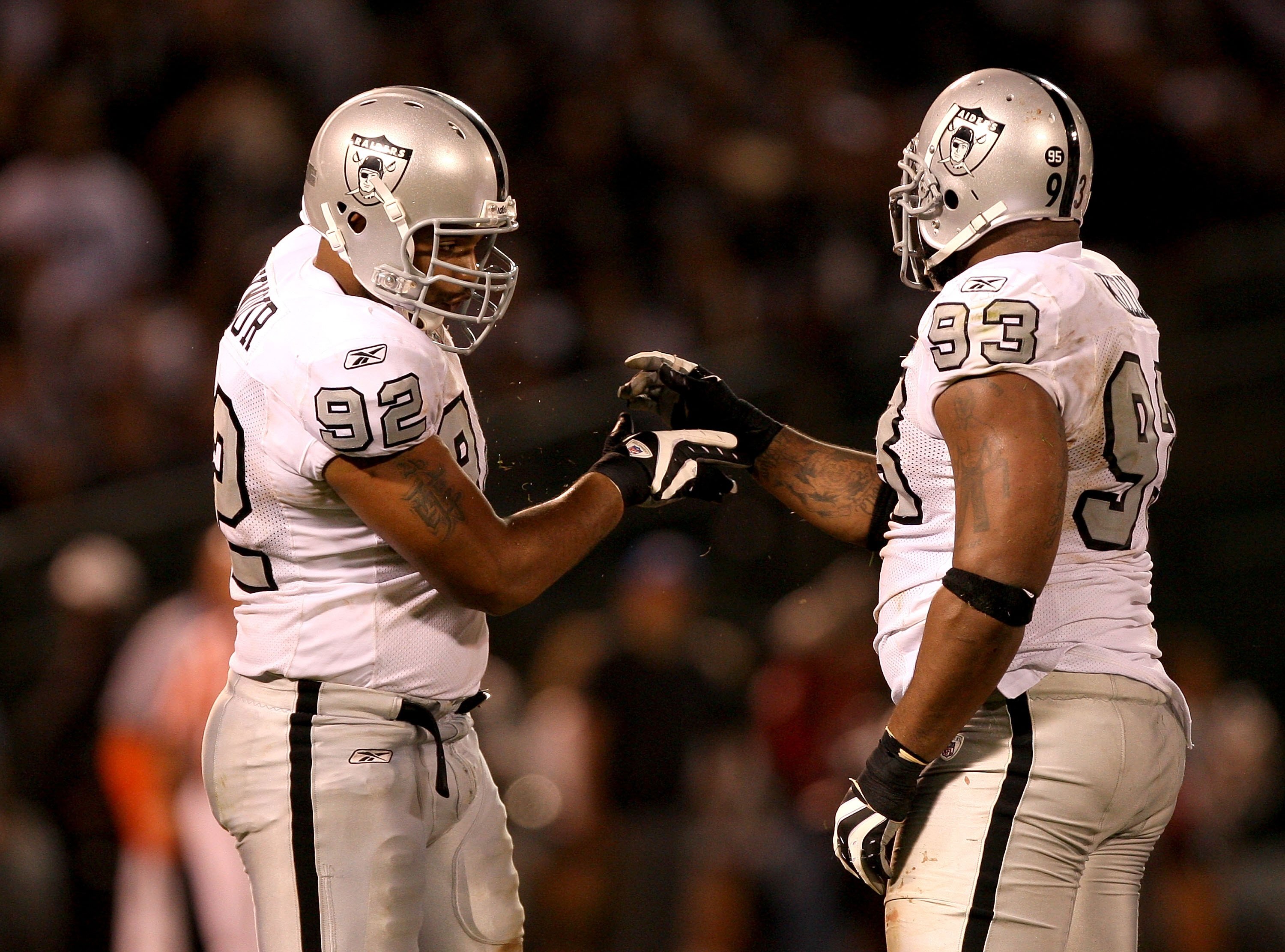 OAKLAND, CA - SEPTEMBER 14:  Richard Seymour #92 and Tommy Kelly #93 of the Oakland Raiders shake hands after a big play during their game against the San Diego Chargers on September 14, 2009 at the Oakland-Alameda County Coliseum in Oakland, California.