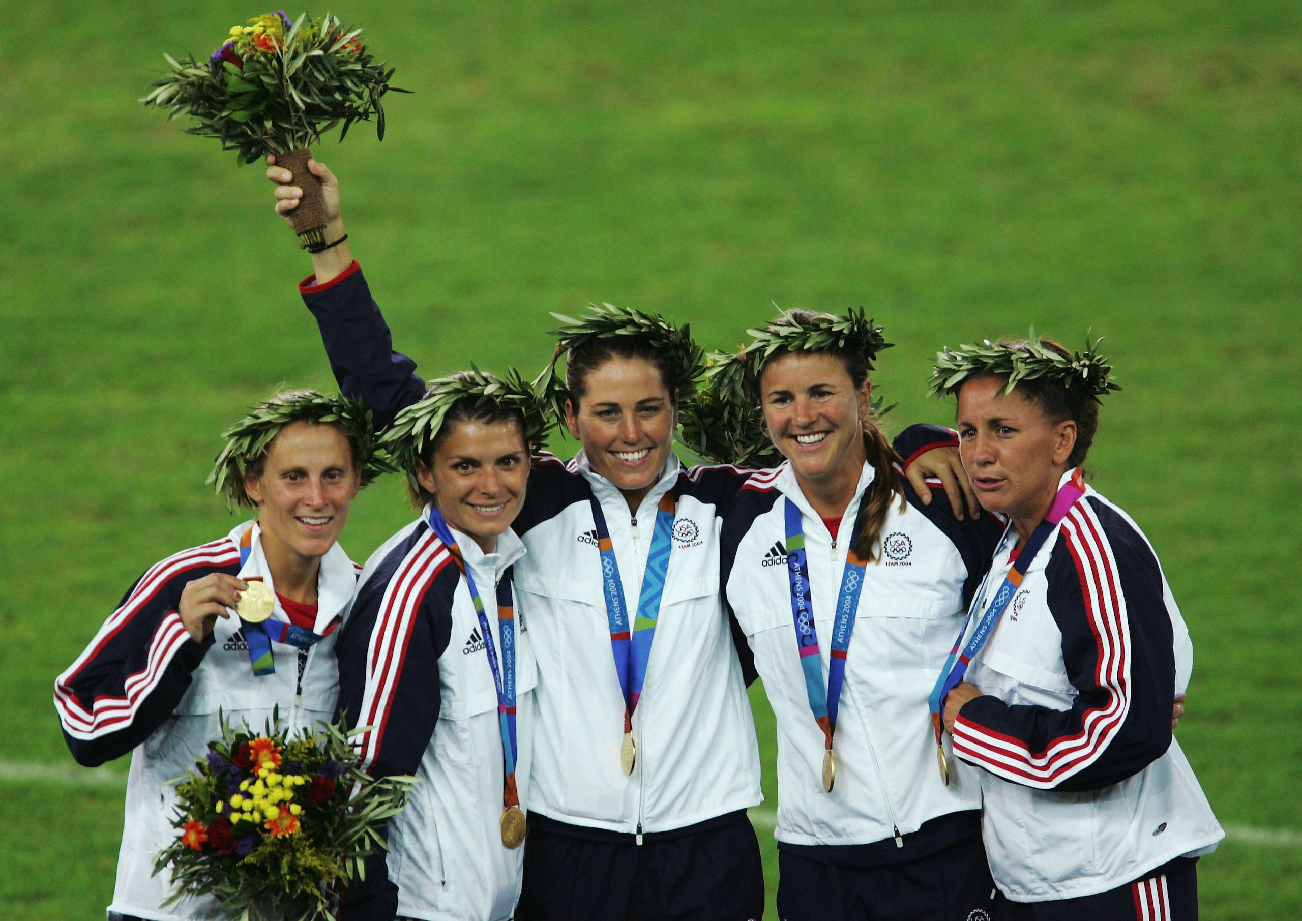 ATHENS - AUGUST 26:   Members of the victorious USA team that beat Brazil 2-1 in extra time stand with their medals on the podium after the women's football match played between Brazil and the USA on August 26, 2004 during the Athens 2004 Summer Olympic G