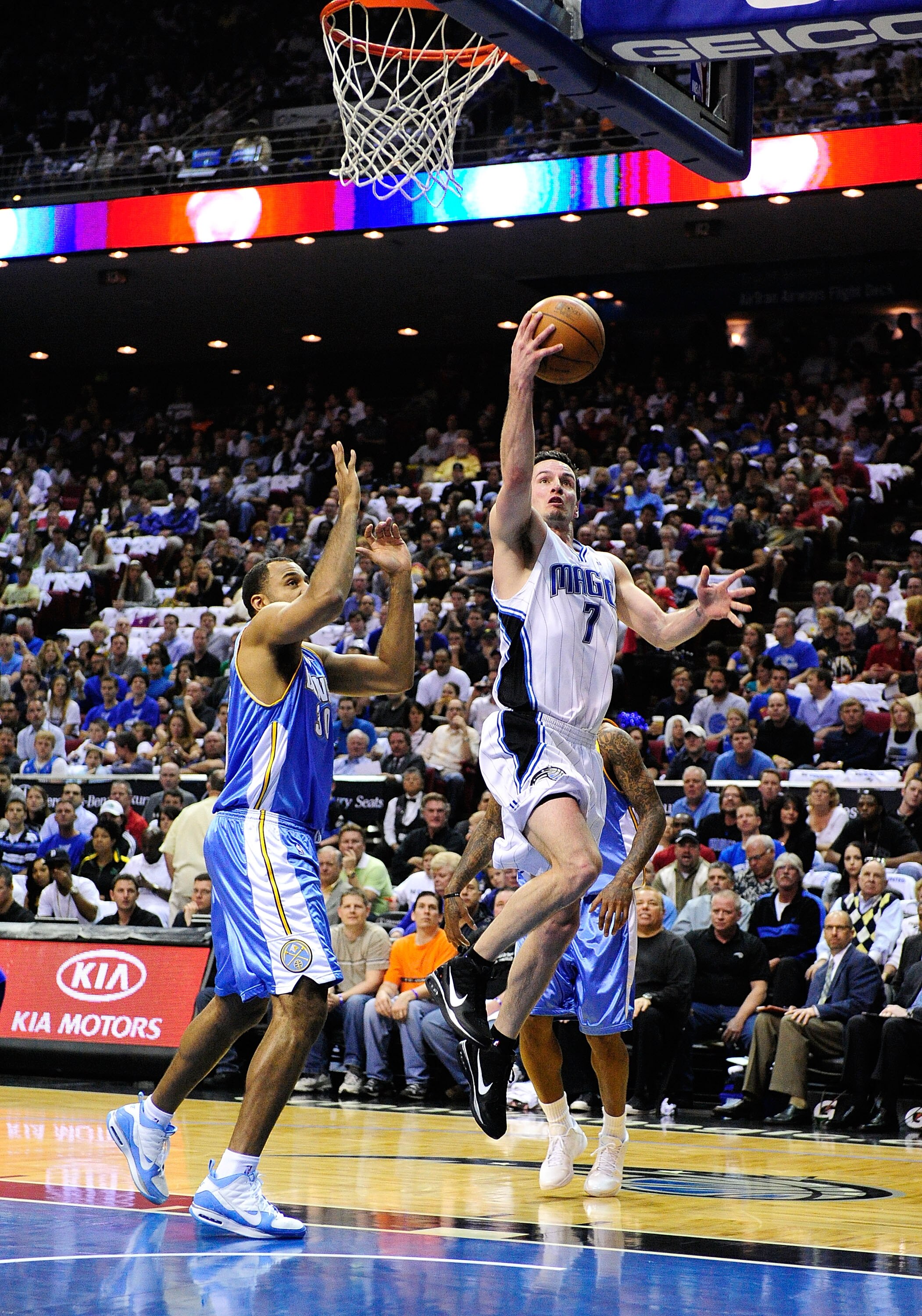 ORLANDO, FL - MARCH 28:  J.J. Redick #7 of the Orlando Magic drives against Malik Allen #30 of the Denver Nuggets during the game at Amway Arena on March 28, 2010 in Orlando, Florida.  NOTE TO USER: User expressly acknowledges and agrees that, by download
