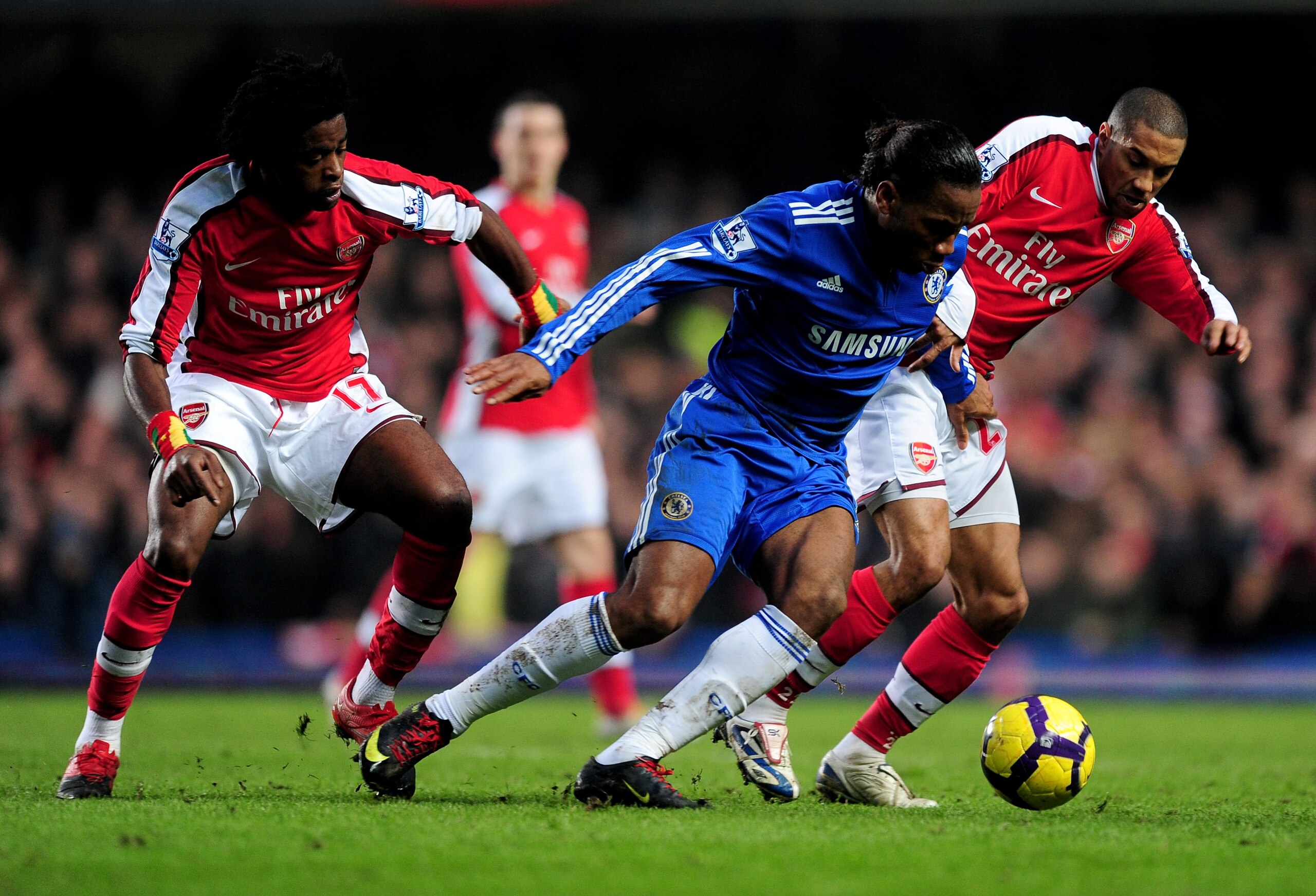 LONDON, ENGLAND - FEBRUARY 07:  Didier Drogba of Chelsea battles for the ball with Alexandre Song and Gael Clichy of Arsenal during the Barclays Premier League match between Chelsea and Arsenal at Stamford Bridge on February 7, 2010 in London, England.  (