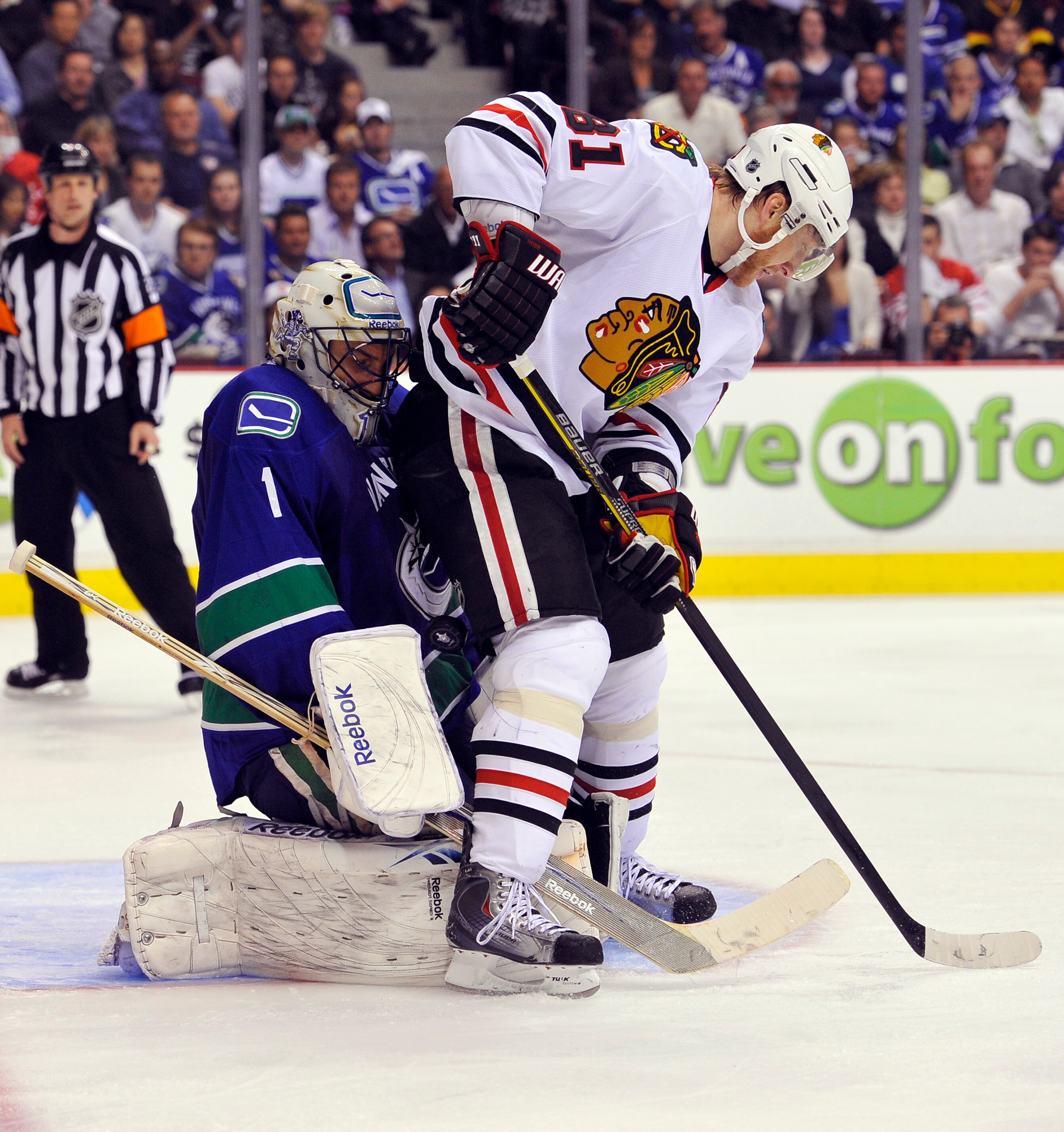 VANCOUVER, CANADA - MAY 11:  Goalie Roberto Luongo #1 of the Vancouver Canucks makes a save with Marian Hossa #81 of the Chicago Blackhawks in close during the second period in Game Six of the Western Conference Semifinals during the 2010 NHL Stanley Cup