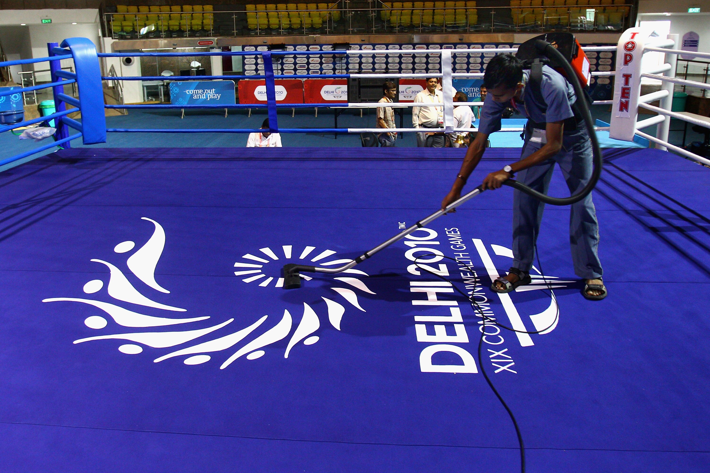 DELHI, INDIA - OCTOBER 03:  A worker clears boxing ring at Talkatora Indoor Stadium ahead of the Delhi 2010 Commonwealth Games, which open this evening, on October 3, 2010 in Delhi, India.  (Photo by Feng Li/Getty Images)