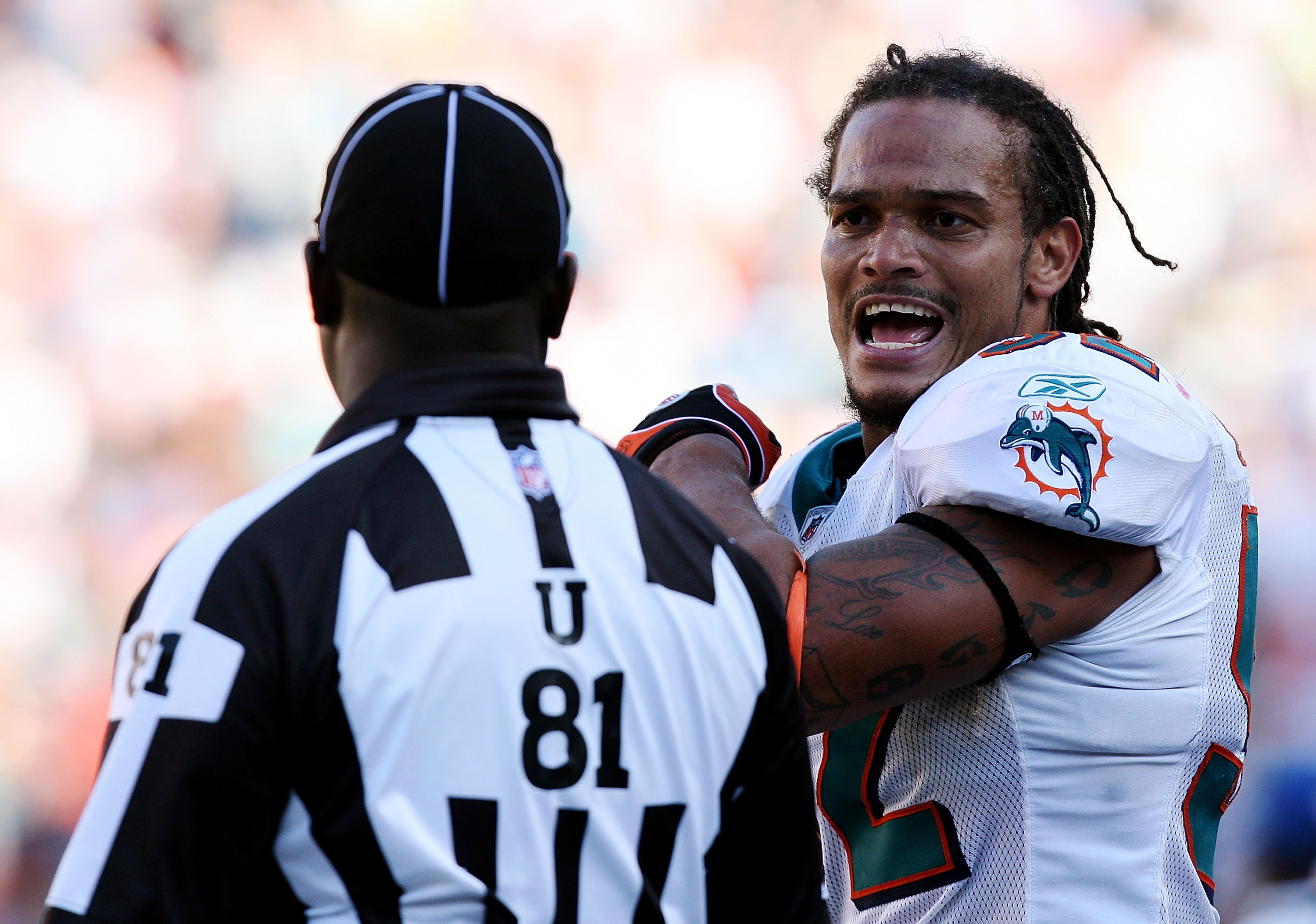 MIAMI - NOVEMBER 23: Linebacker Channing Crowder #52 of the Miami Dolphins argues with umpire Roy Ellison #81 before being ejected while taking on the New England Patriots at Dolphin Stadium on November 23, 2008 in Miami, Florida. The Patriots defeated th