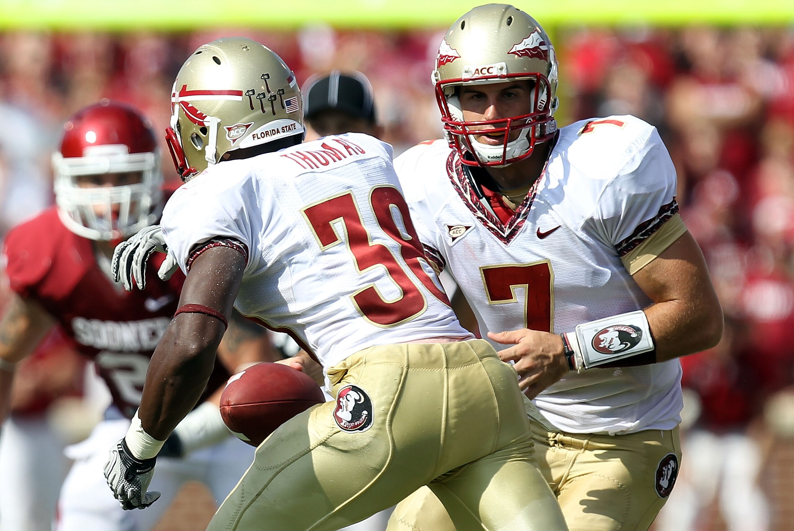 NORMAN, OK - SEPTEMBER 11: Quarterback Christian Ponder #7 of the Florida State Seminoles hands the ball off to Jermaine Thomas #38 against the Oklahoma Sooners at Gaylord Family Oklahoma Memorial Stadium on September 11, 2010 in Norman, Oklahoma. (Phot NORMAN, OK - SEPTEMBER 11: Quarterback Christian Ponder #7 of the Florida State Seminoles hands the ball off to Jermaine Thomas #38 against the Oklahoma Sooners at Gaylord Family Oklahoma Memorial Stadium on September 11, 2010 in Norman, Oklahoma. (Phot