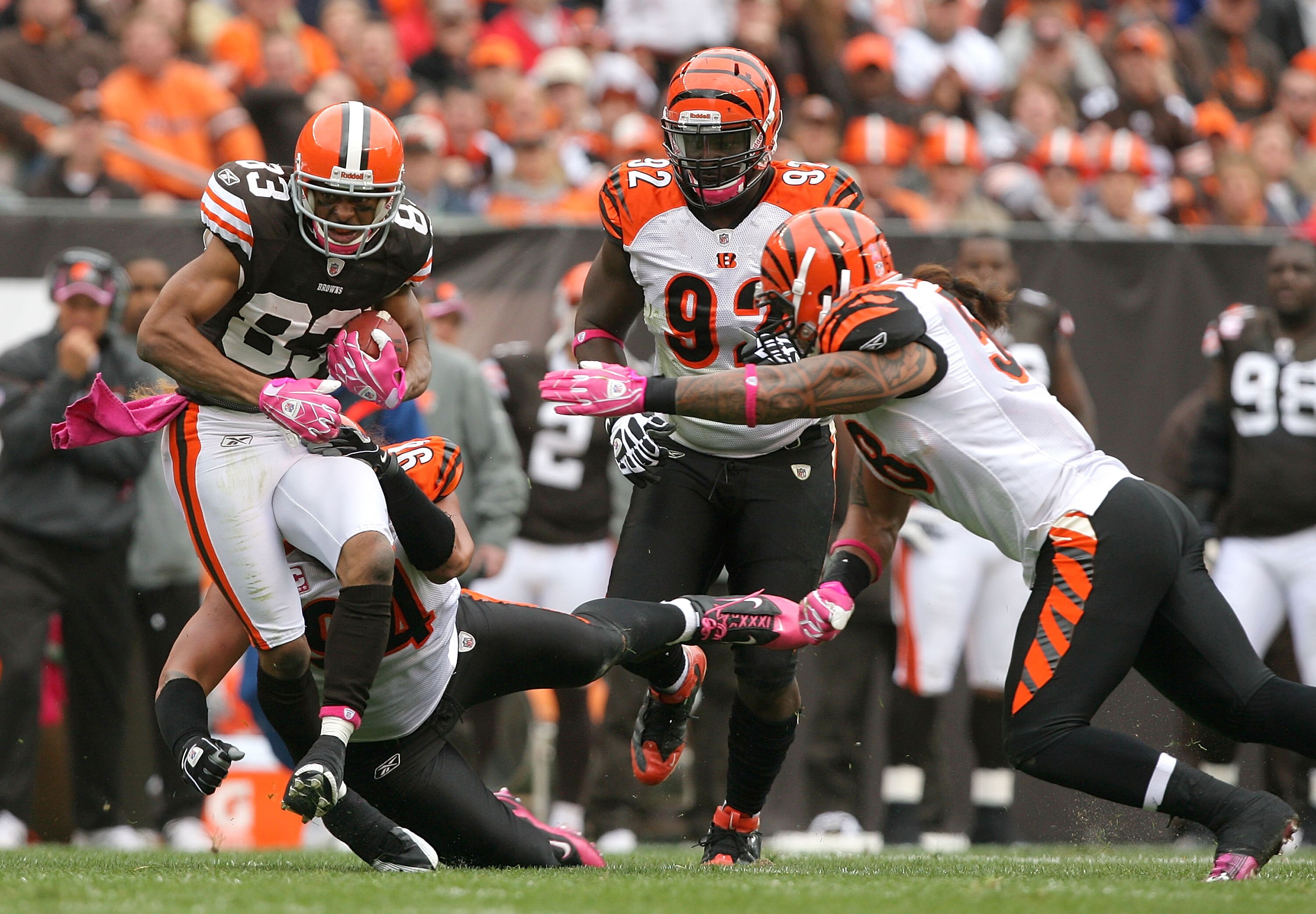 CLEVELAND - OCTOBER 03:  Wide receiver Chansi Stuckey #83 of the Cleveland Browns is hit by defenders Domata Peko #94, Frostee Rucker #92 and Rey Maualuga #58 of the Cincinnati Bengals at Cleveland Browns Stadium on October 3, 2010 in Cleveland, Ohio.  (P