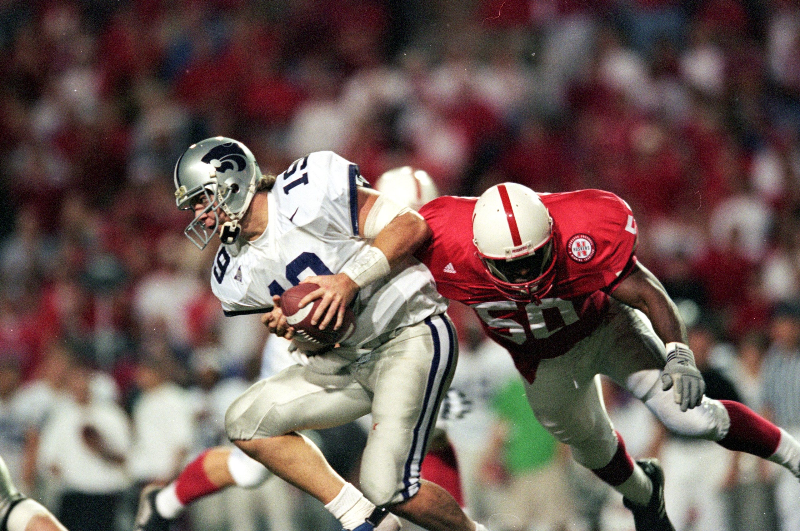 13 Nov 1999: Adam Helm #19 of the Kansas State Wildcats scrambles with the ball as he misses the sack by Julius Jackson #50 of the   Nebraska Cornhuskers at the Memorial Stadium in Lincoln, Nebraska. The Cornhuskers defeated the Wildcats 41-15. Mandatory