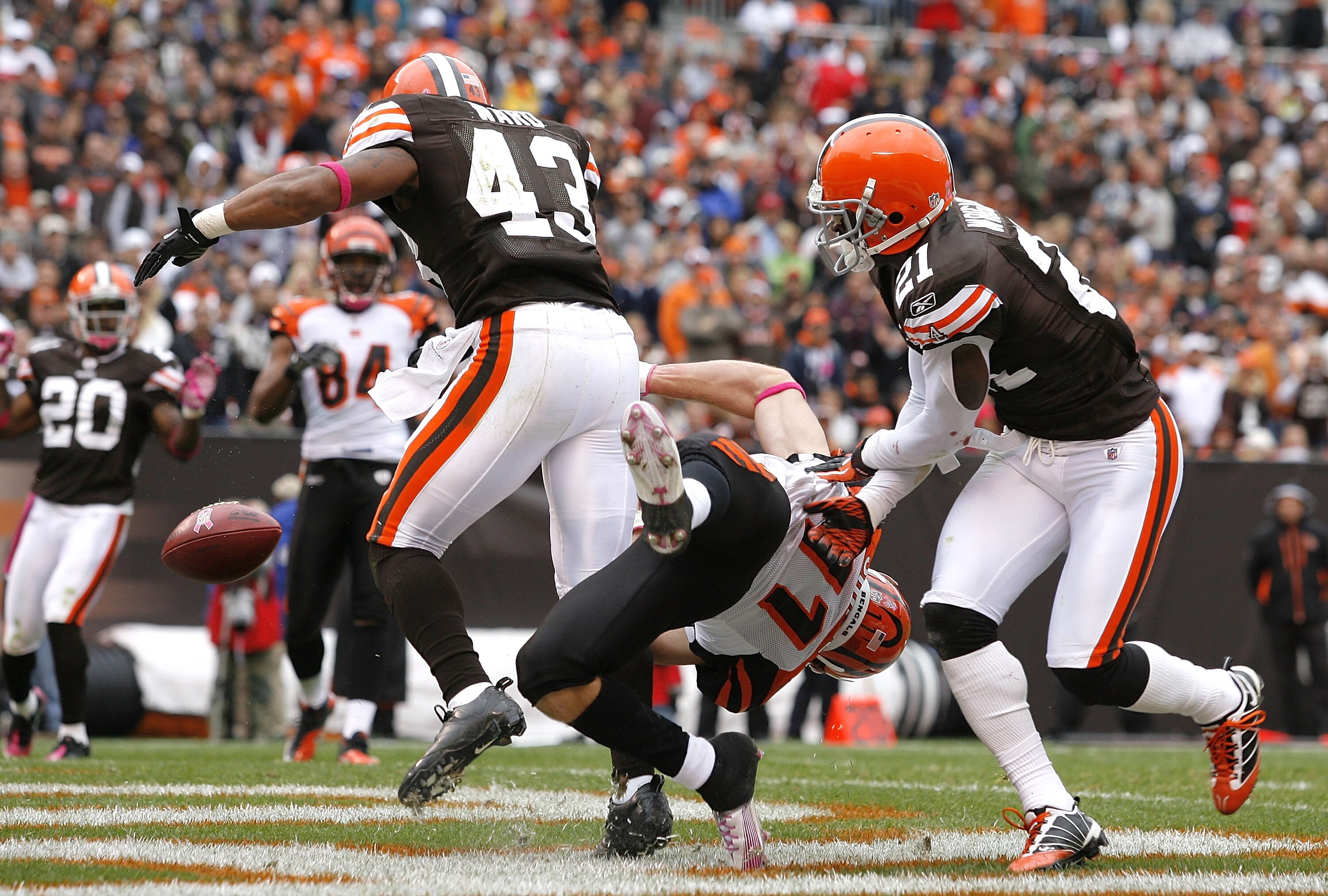 CLEVELAND - OCTOBER 03:  Defenders T.J. Ward #43 and Eric Wright #21 of the Cleveland Browns break up a pass to wide receiver Jordan Shipley #11 of the Cincinnati Bengals at Cleveland Browns Stadium on October 3, 2010 in Cleveland, Ohio.  (Photo by Matt S